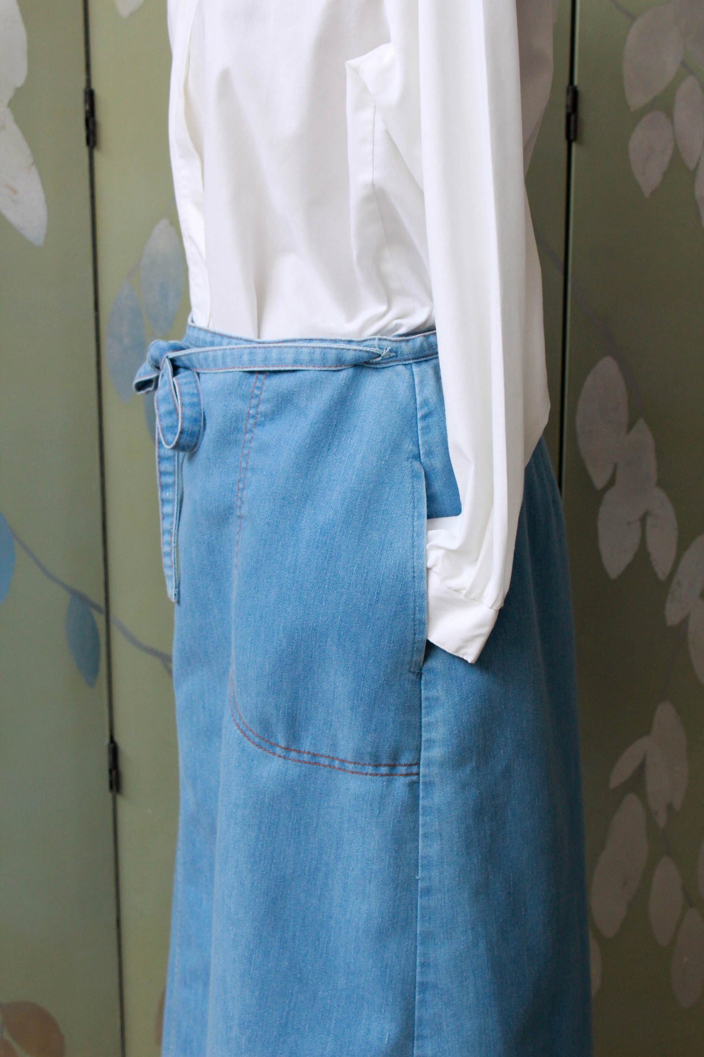 90s vintage chambray light blue jean wrap skirt with waist tie, side pockets, a-line silhouette