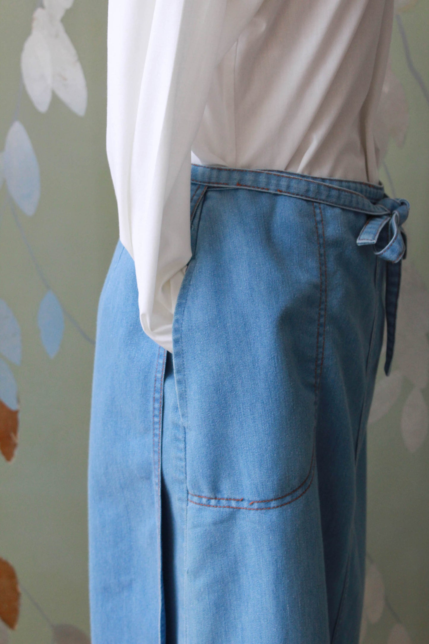 90s vintage chambray light blue jean wrap skirt with waist tie, side pockets, a-line silhouette