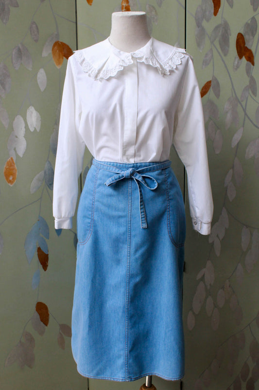 90s vintage chambray light blue jean wrap skirt with waist tie, side pockets, a-line silhouette