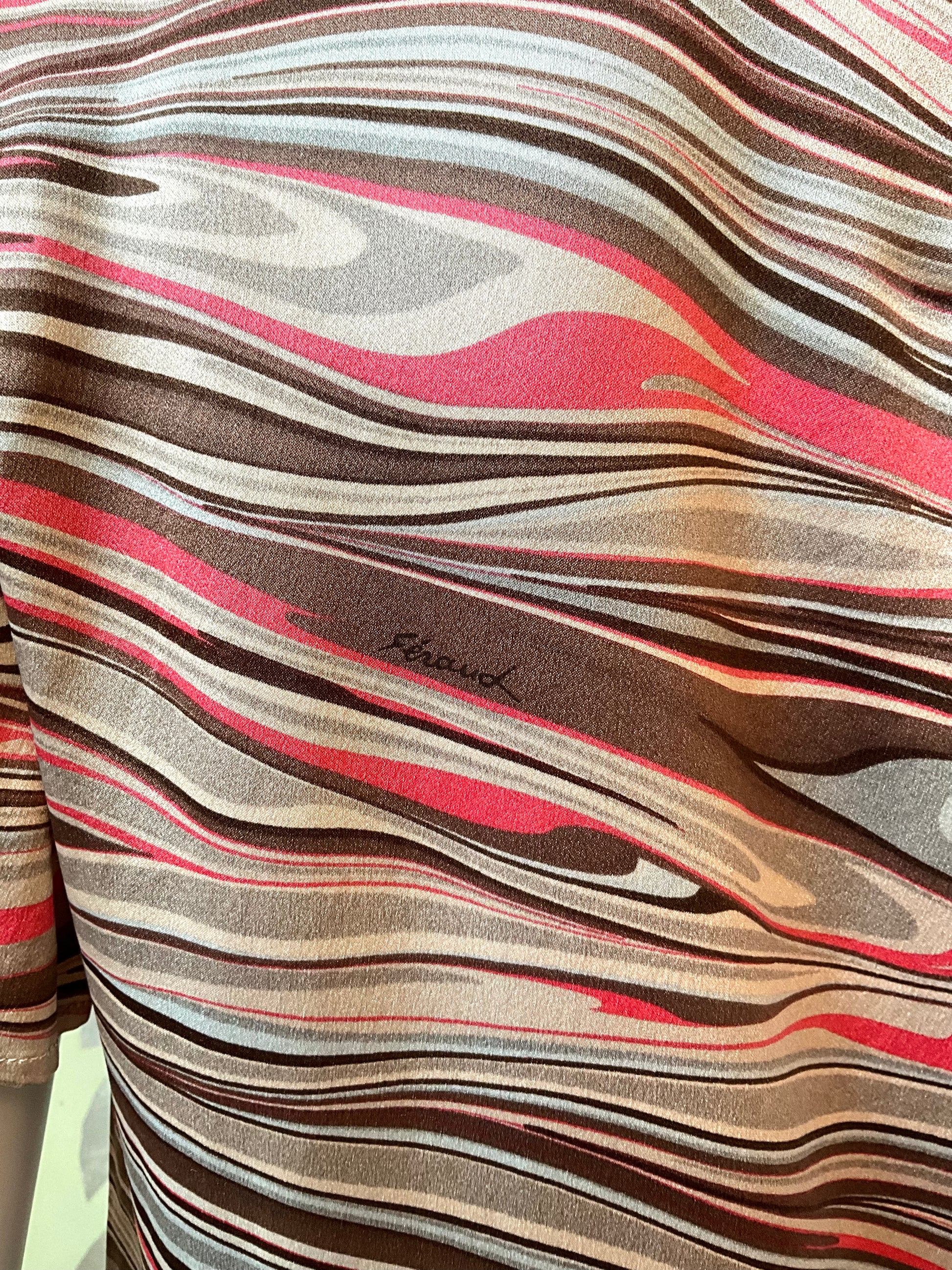 Close-up of a fabric with wavy pattern in brown, pink, and grey colors.