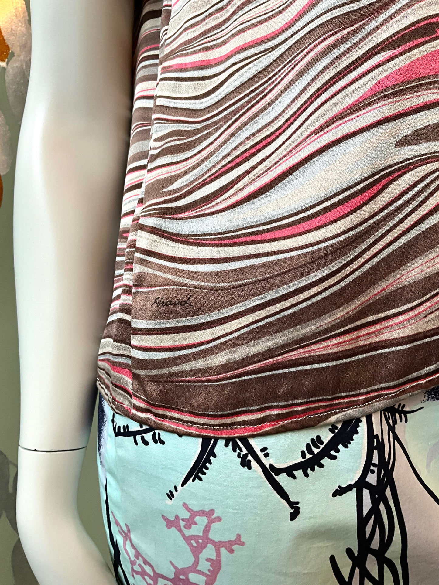 Mannequin wearing a patterned top with 'Feraud' branding.