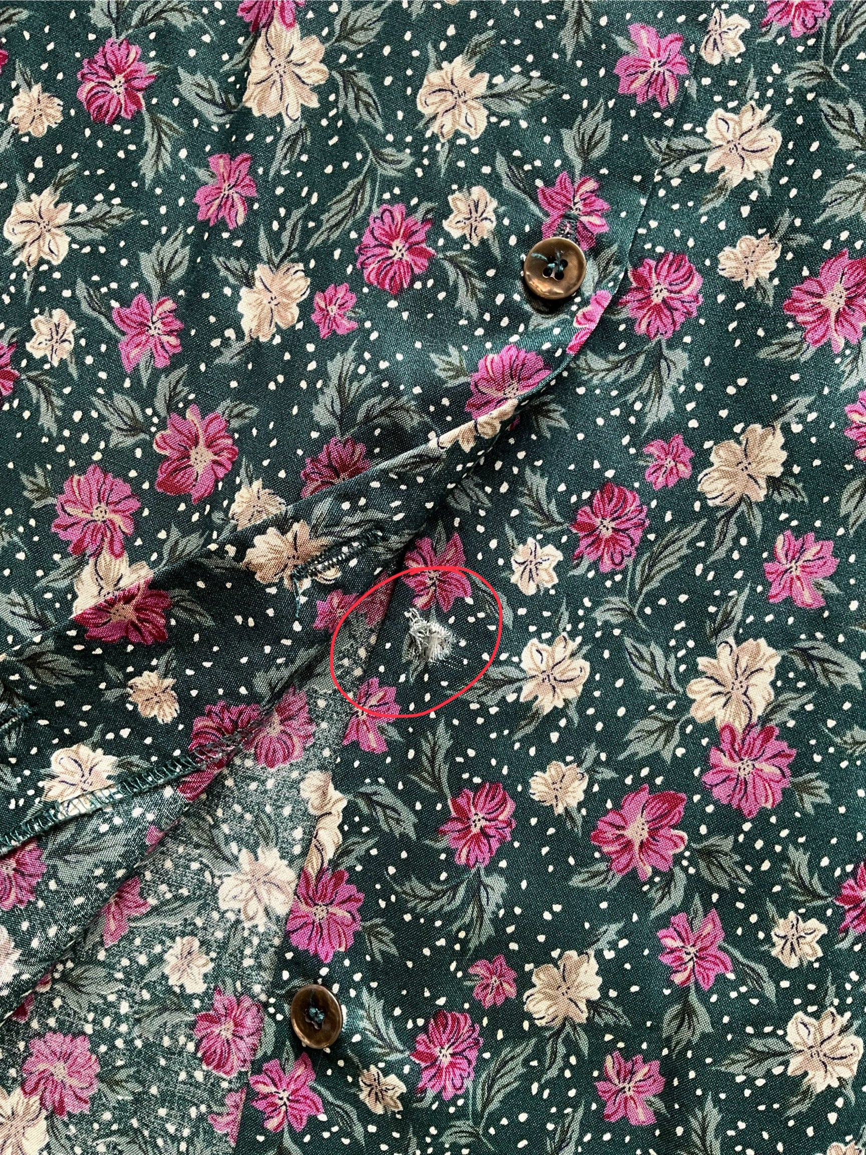 Floral patterned fabric with pink and white flowers on a dark green background