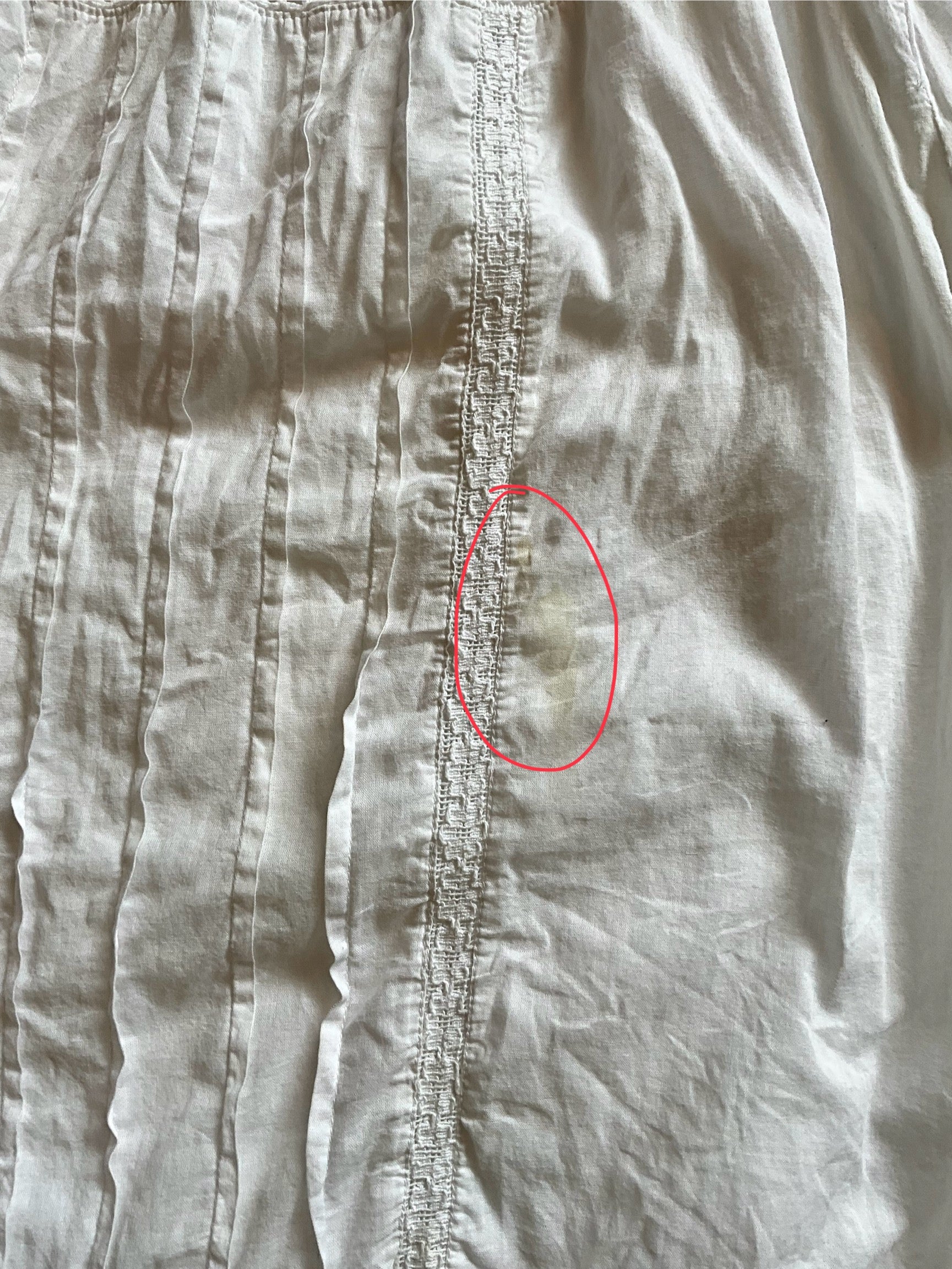 Close-up of a fabric with a red circle highlighting a small defect.
