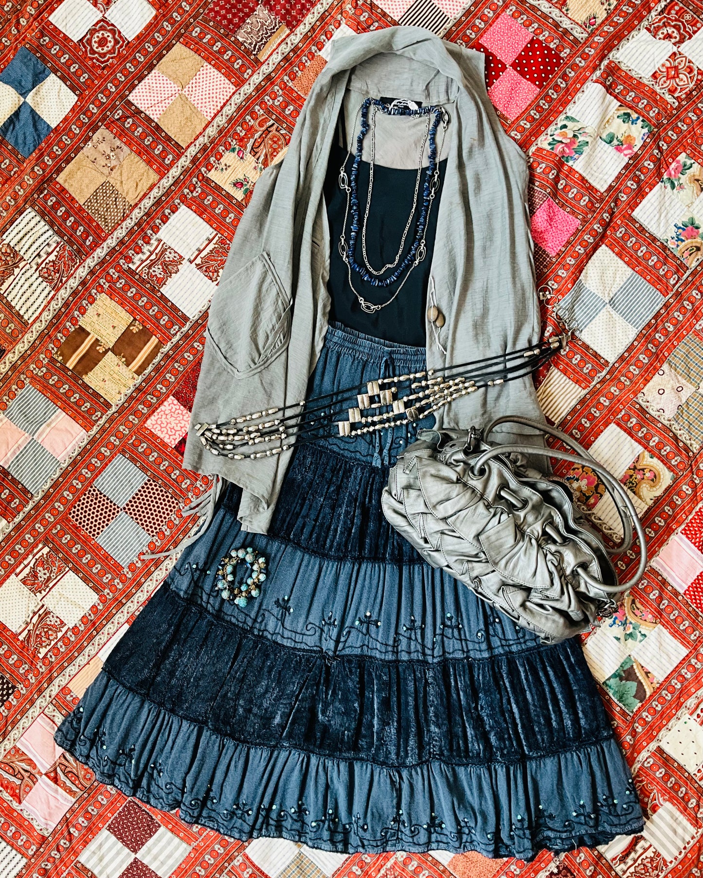 grey boho skirt outfit laid flat on quilt 
