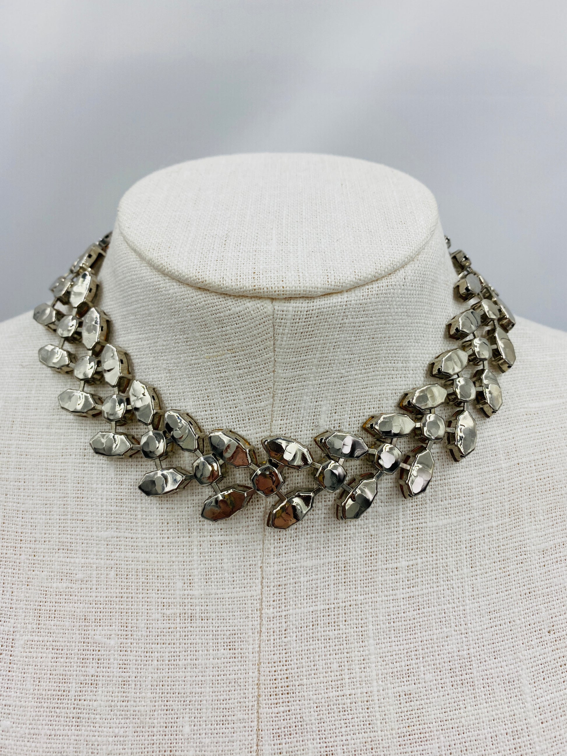 Underside of Vintage 1950s Crystal Marquise Rhinestone Choker Necklace showing silver metal. 