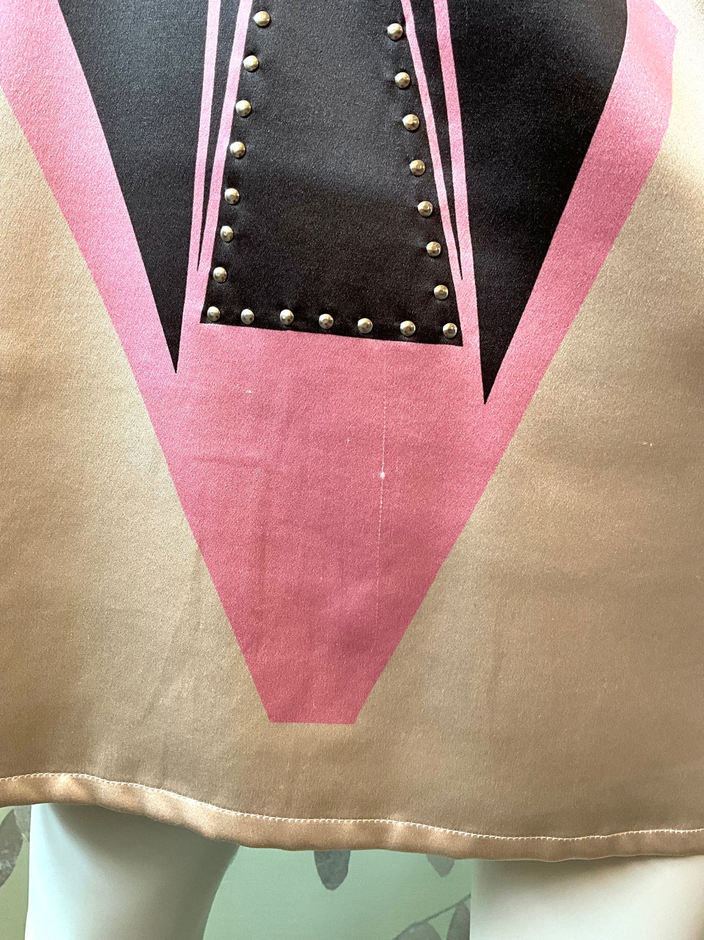 Close-up of a garment hem featuring pink and beige colors.