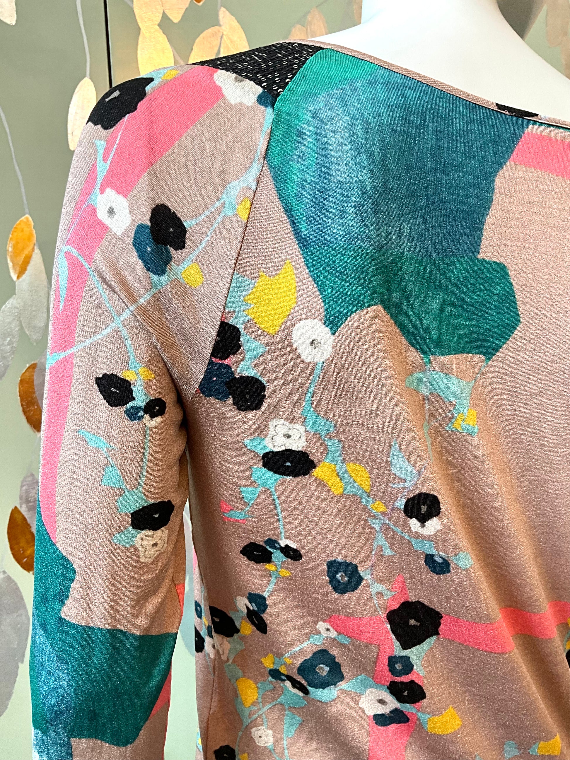 Colorful floral-patterned fabric on a mannequin with a neutral background