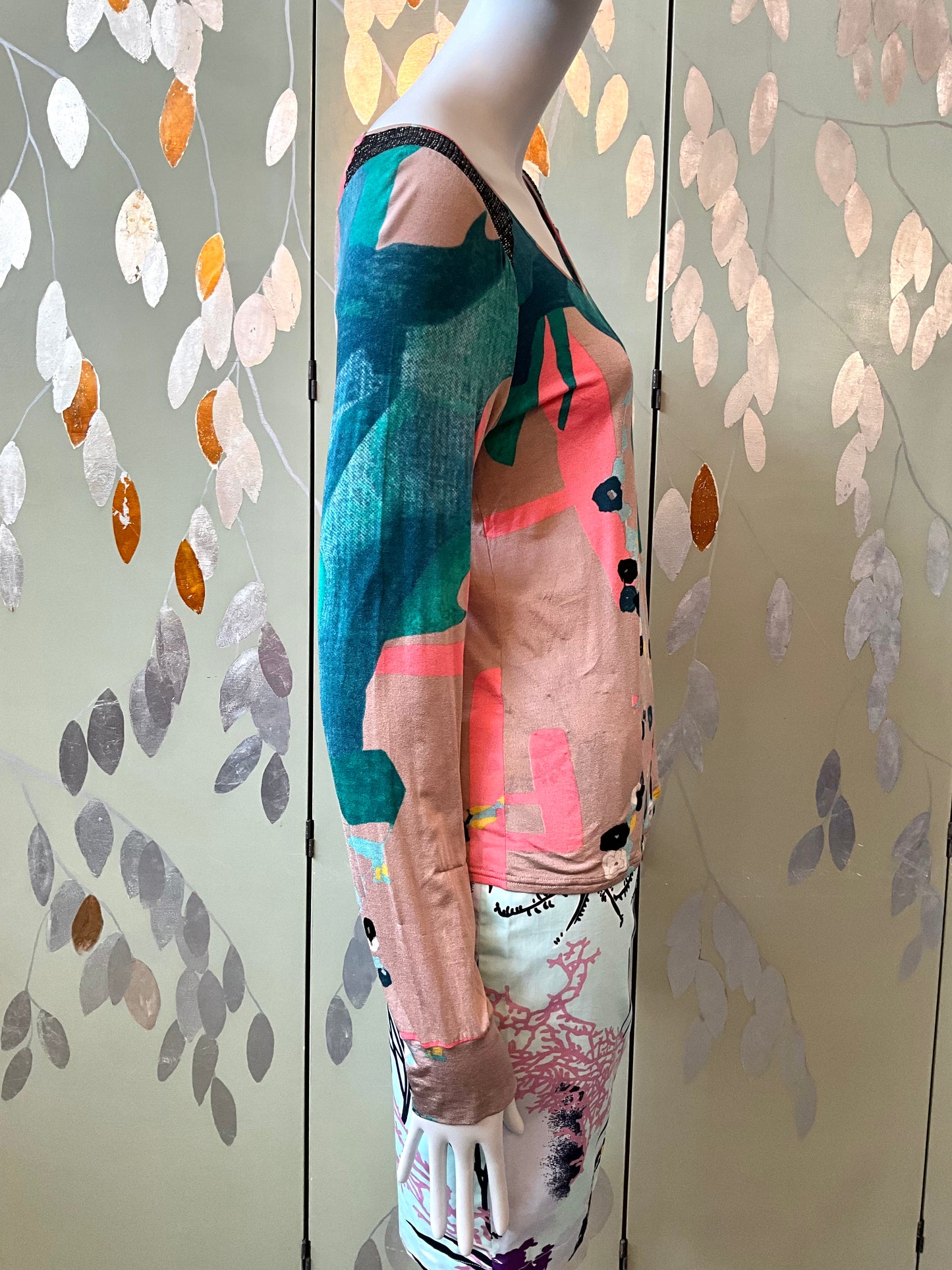 Mannequin wearing a colorful outfit with a patterned background