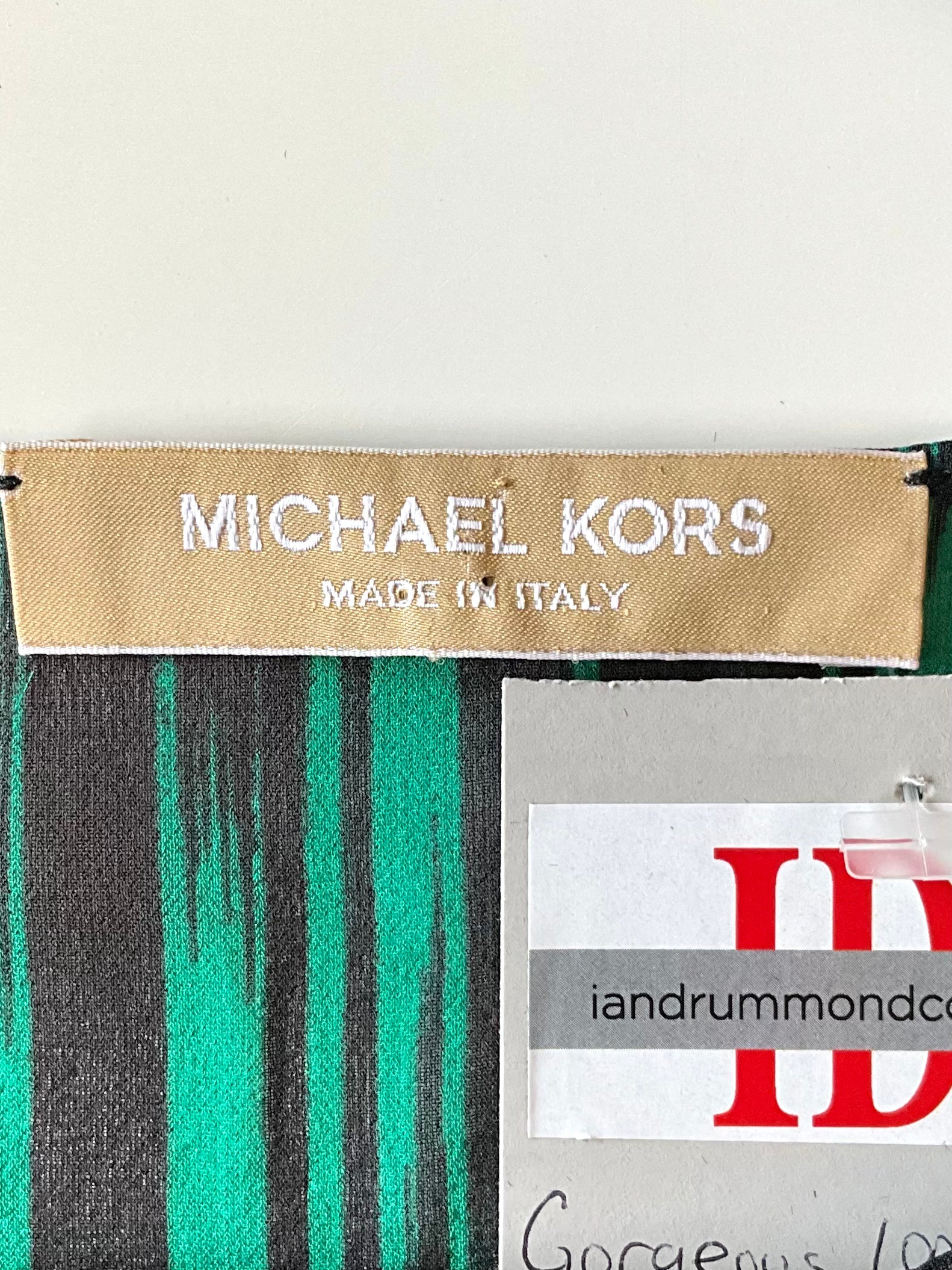 Michael Kors label on a green and black striped fabric 