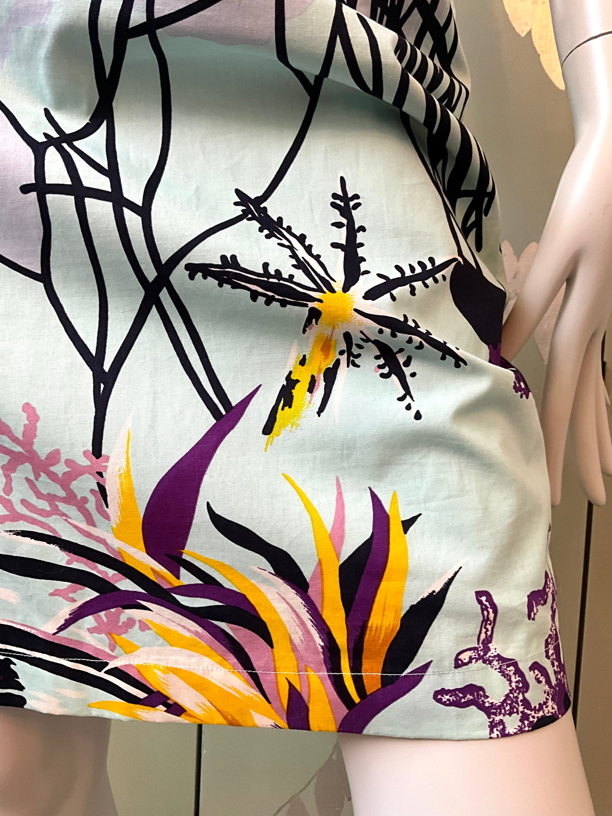 Close-up of a colorful floral patterned skirt on a mannequin.