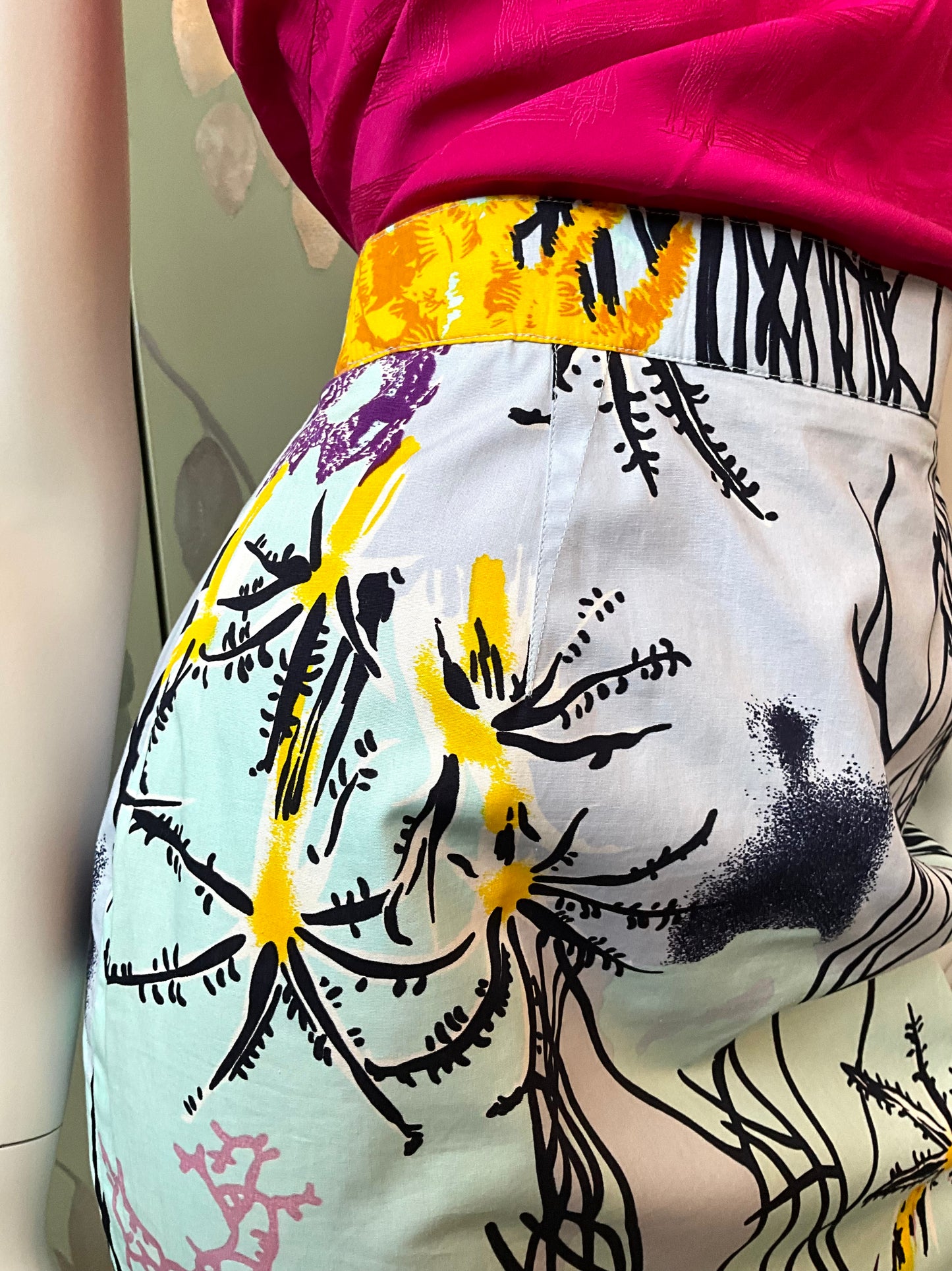 mannequin wearing a colorful skirt with abstract patterns