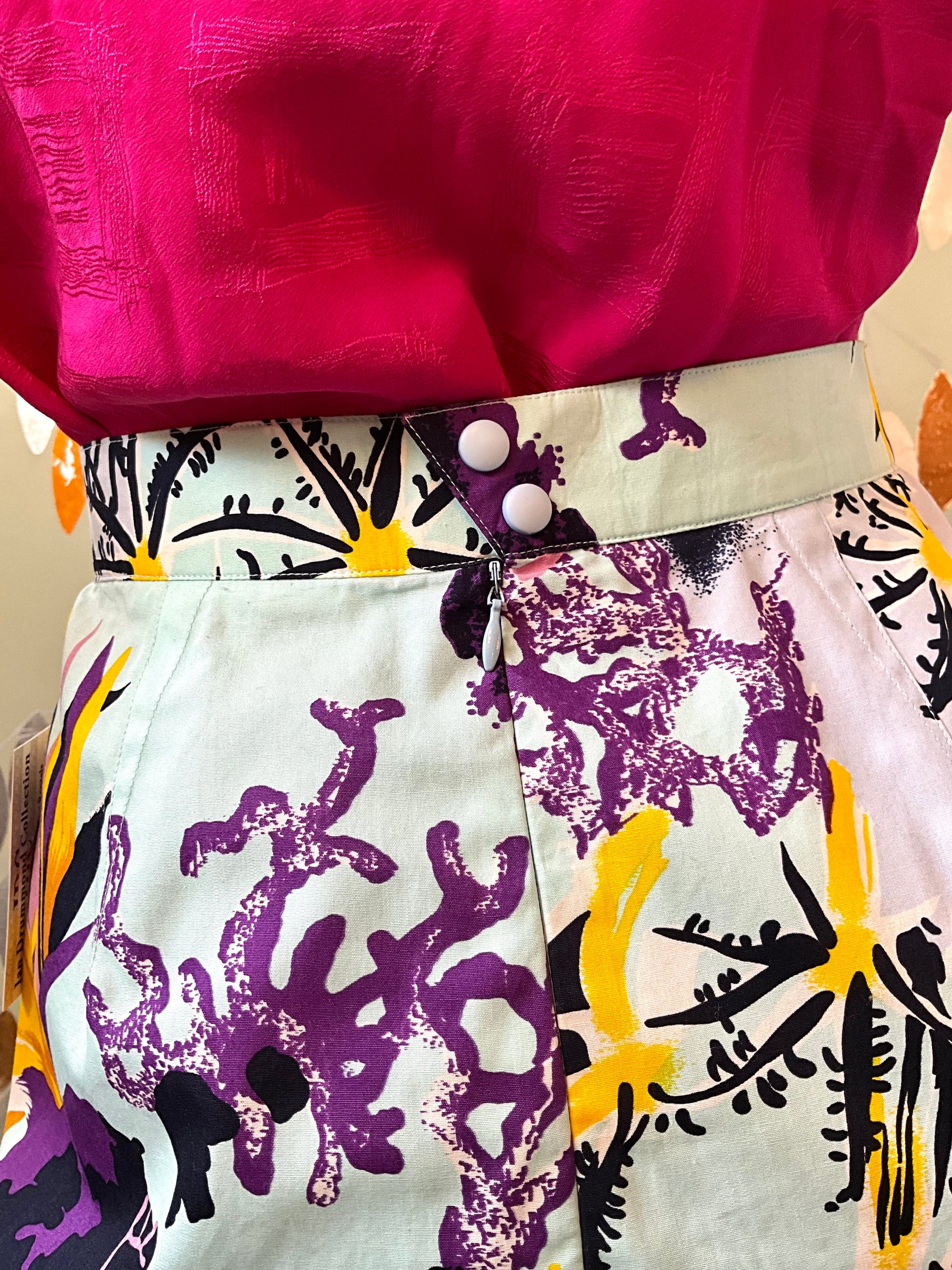 Close-up of a colorful outfit with a patterned skirt