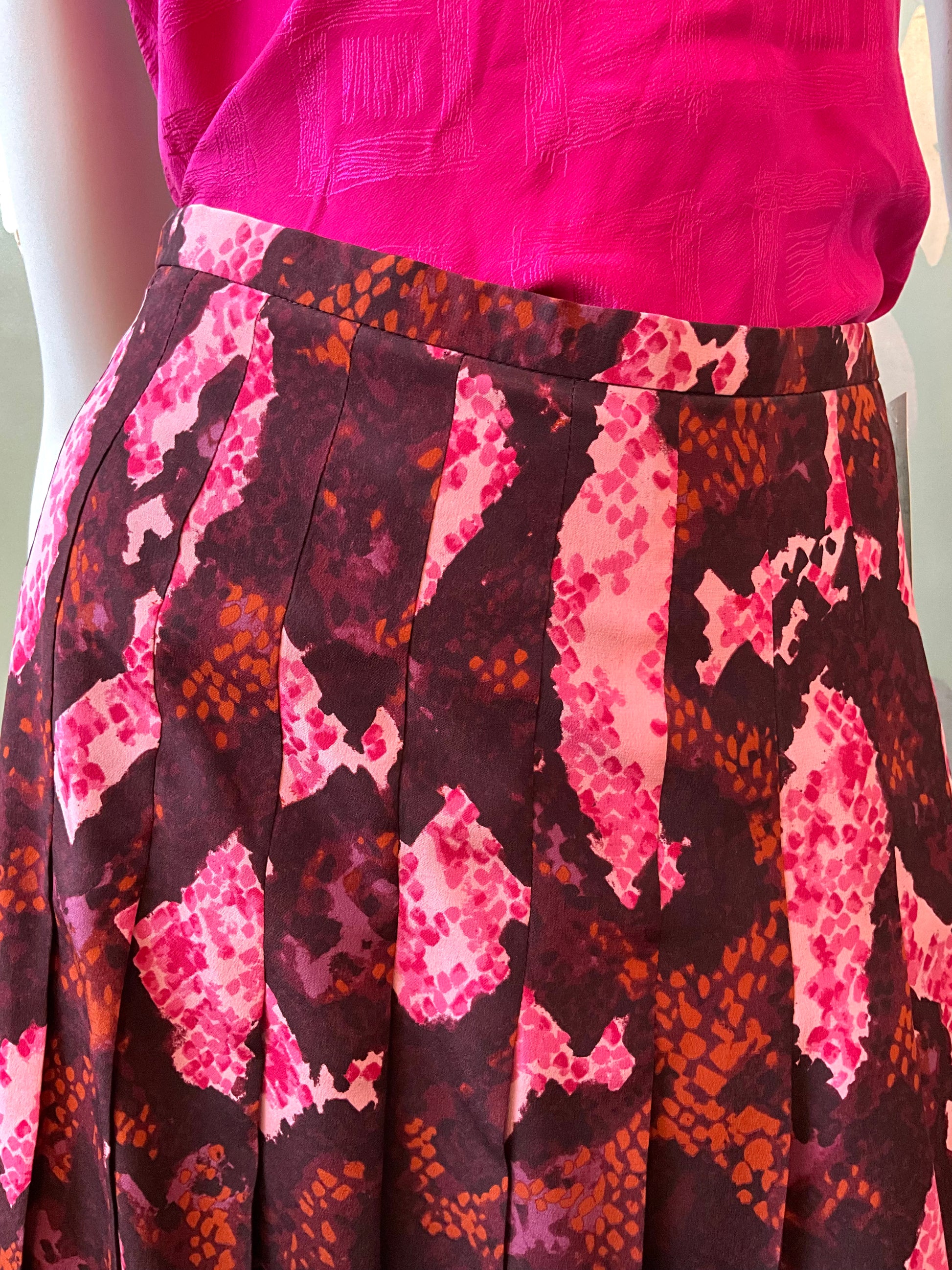 Skirt with pink and brown pattern on a mannequin against a white background