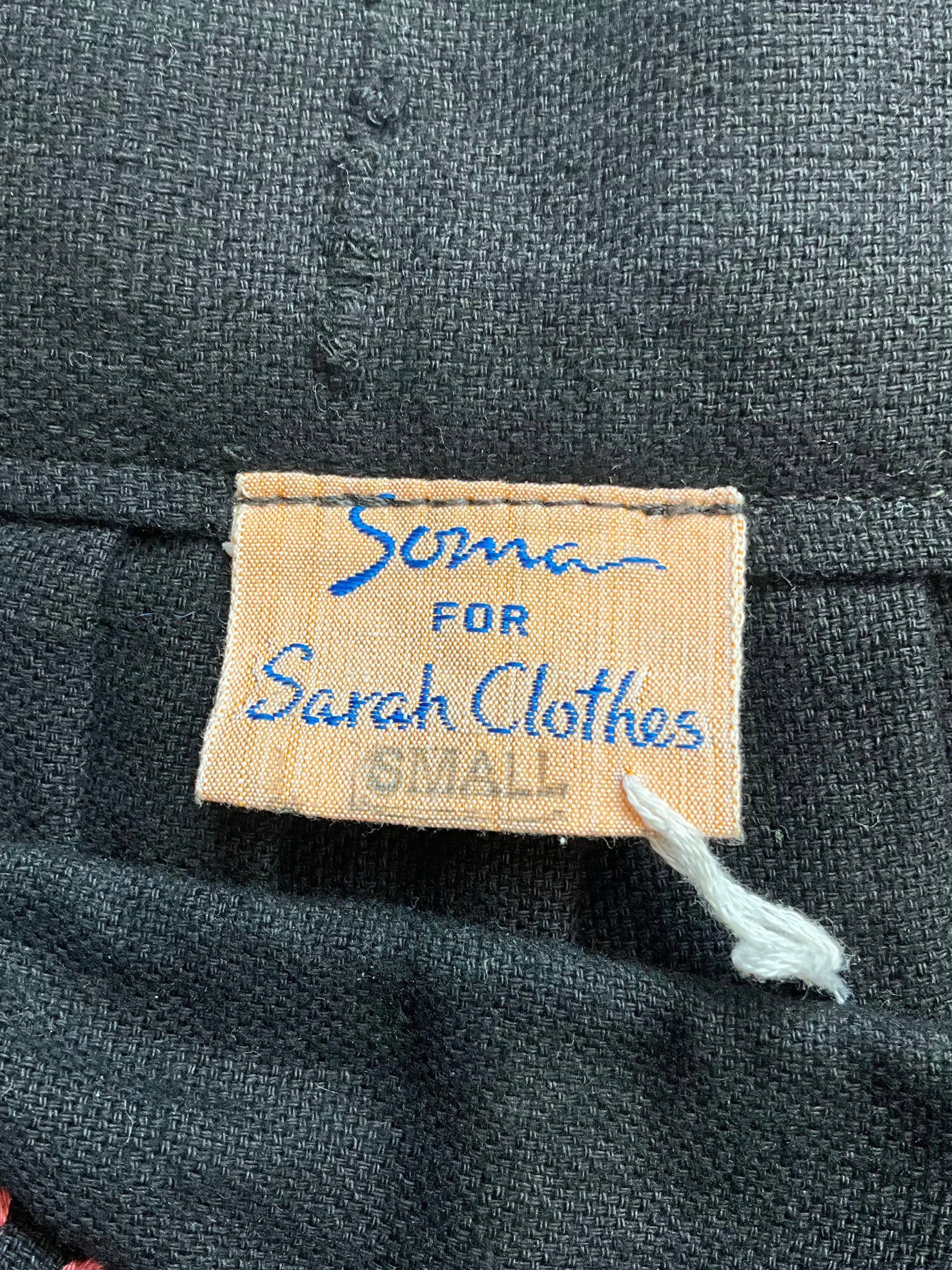 Fabric label on a black fabric with 'Soma for Sarah Clothes' text