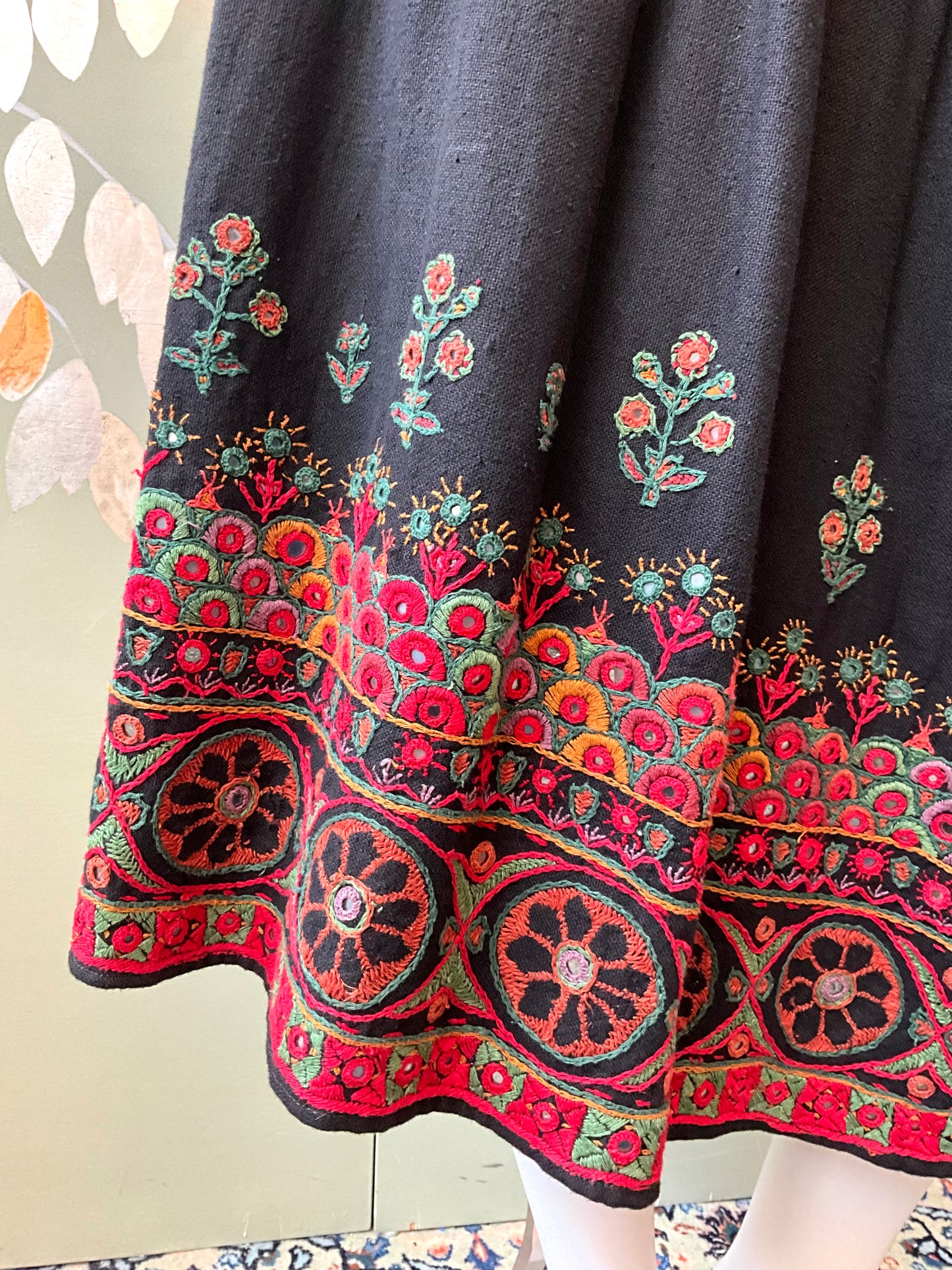 Black fabric with colorful floral embroidery 