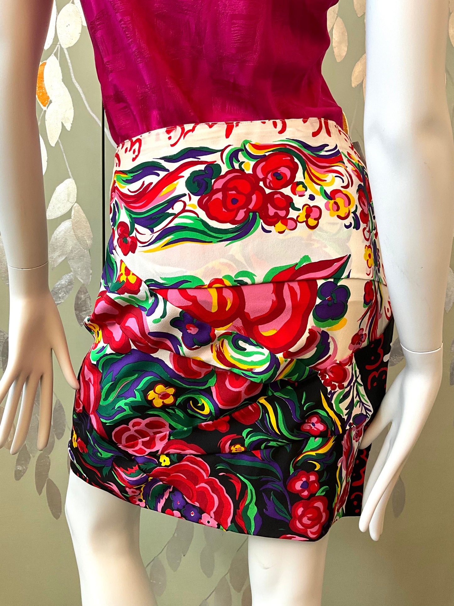 Colorful floral skirt on a mannequin with a patterned background