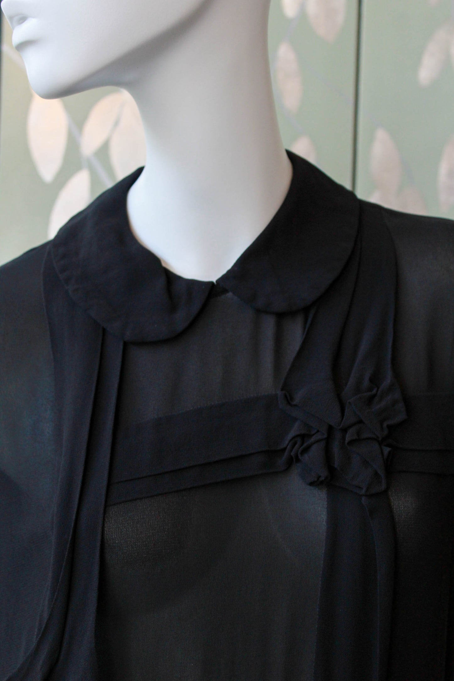 comme des garcons sheer black dress with peterpan collar, gathered skirt, short sleeves, pleated know detail on front, midi length