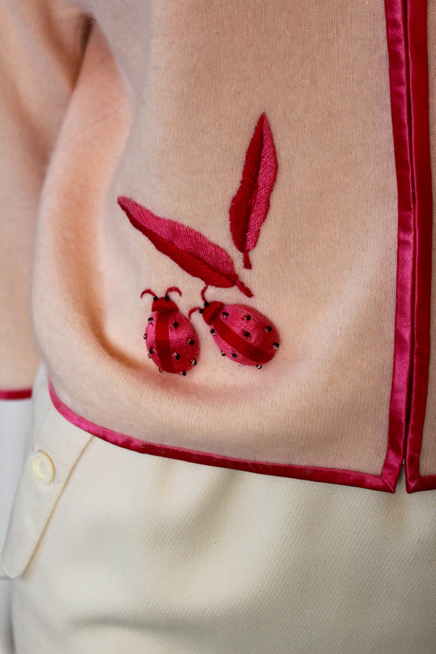 1950s lanvin cashmere pale peach pink cardigan with hot pink embroidered ladybugs and leaves, novelty vintage appliqued cardigan