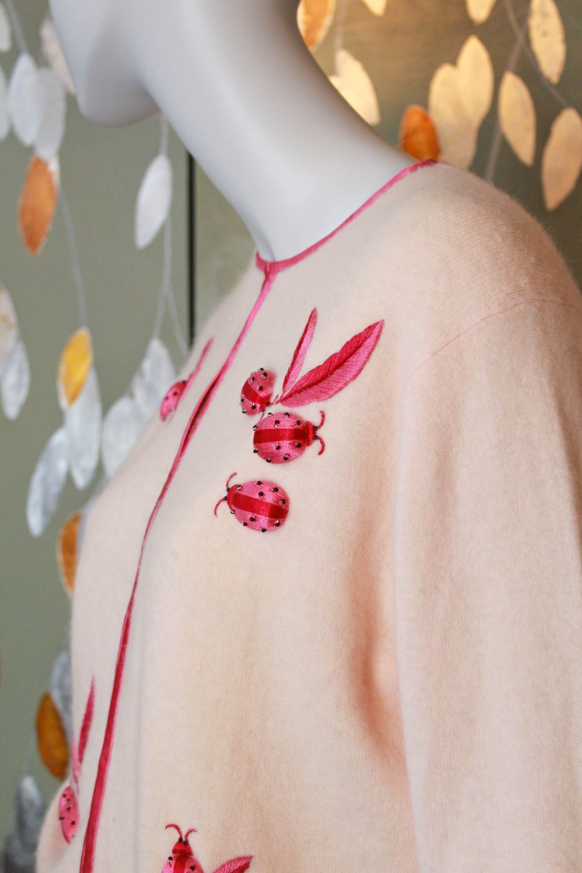 1950s lanvin cashmere pale peach pink cardigan with hot pink embroidered ladybugs and leaves, novelty vintage appliqued cardigan