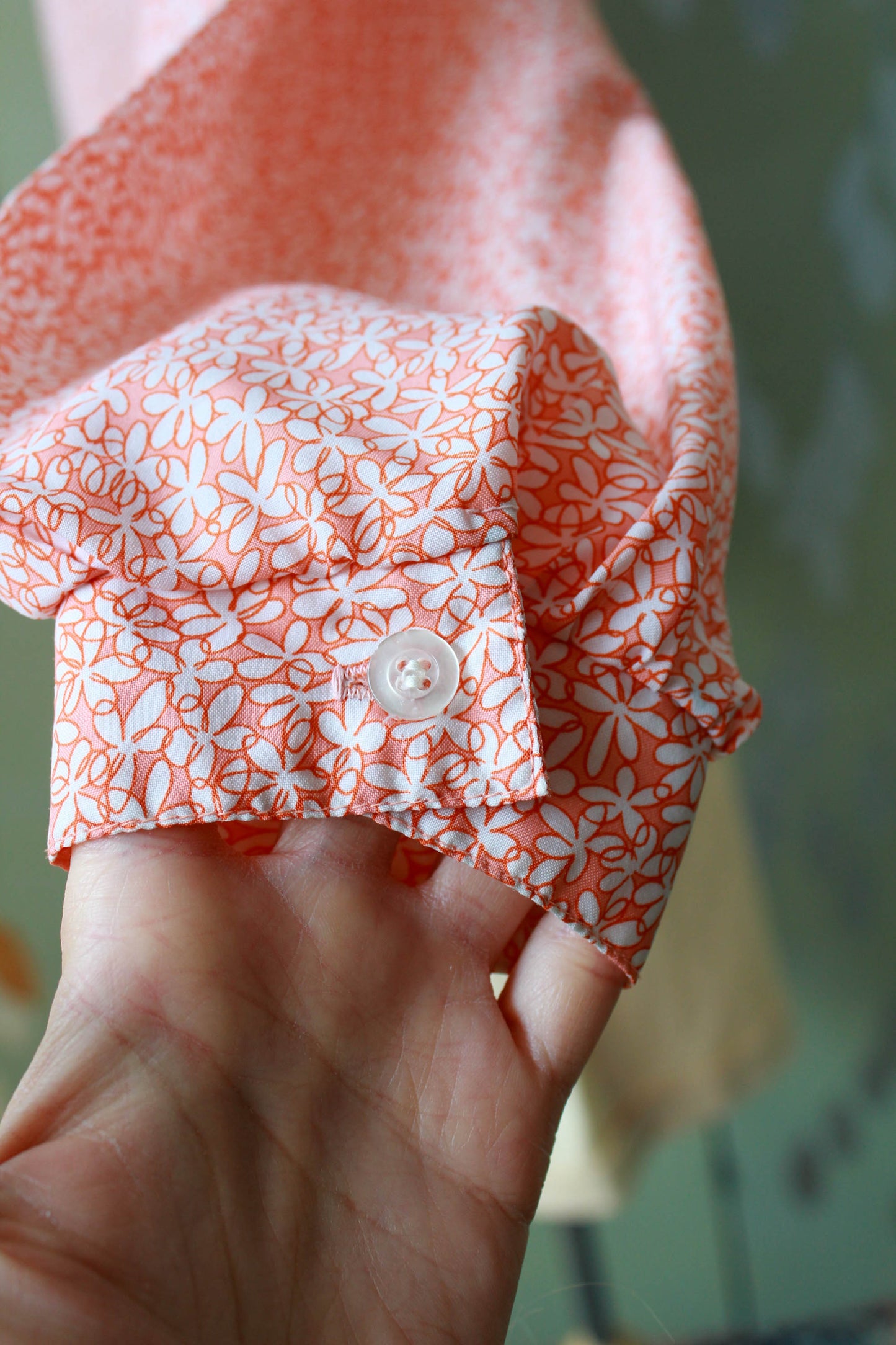1980s holt renfrew orange and white micro floral print blouse with collar and tie at the neck, long sleeves vintage