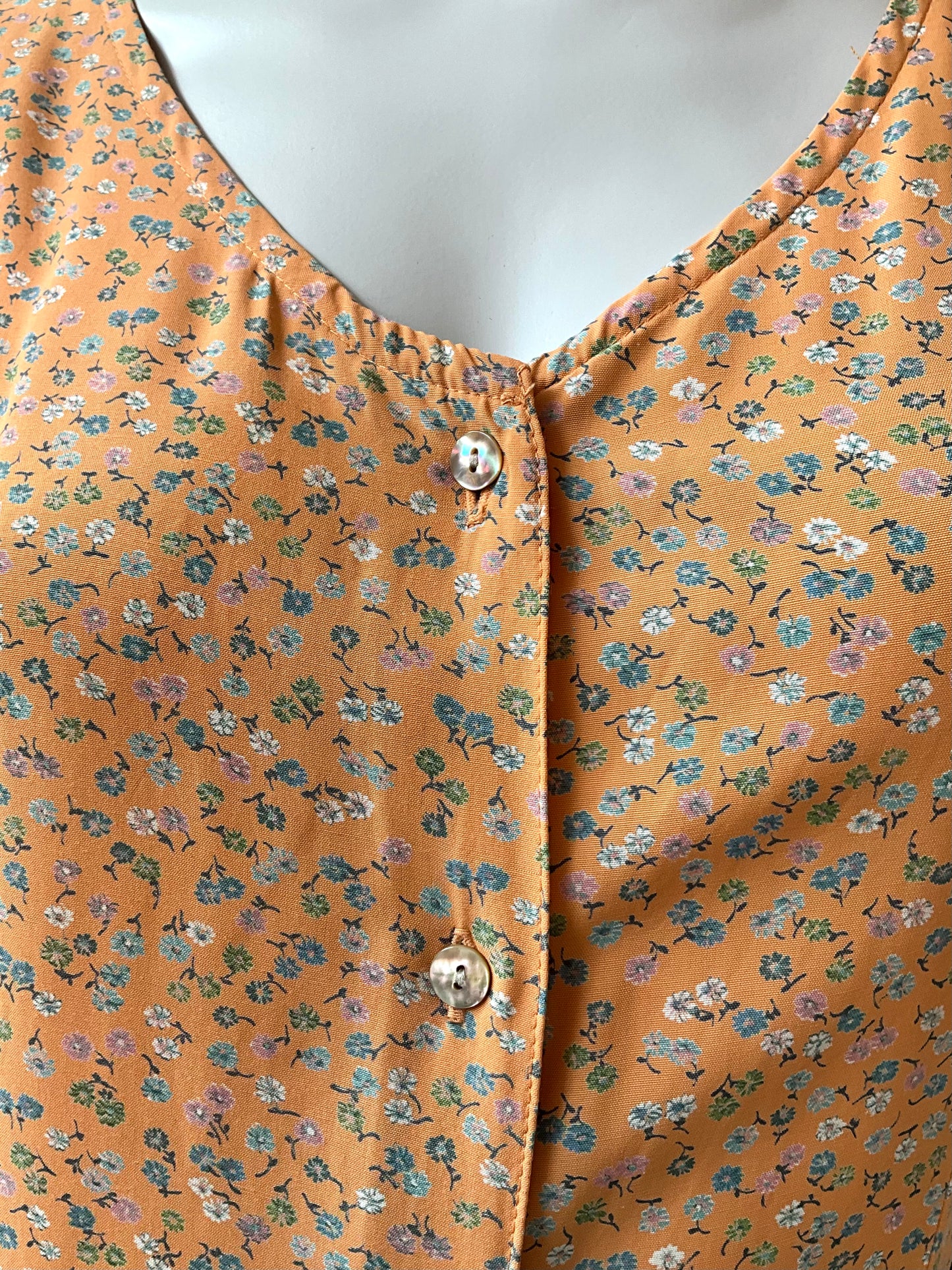 Close-up of a floral-patterned dress on a mannequin.