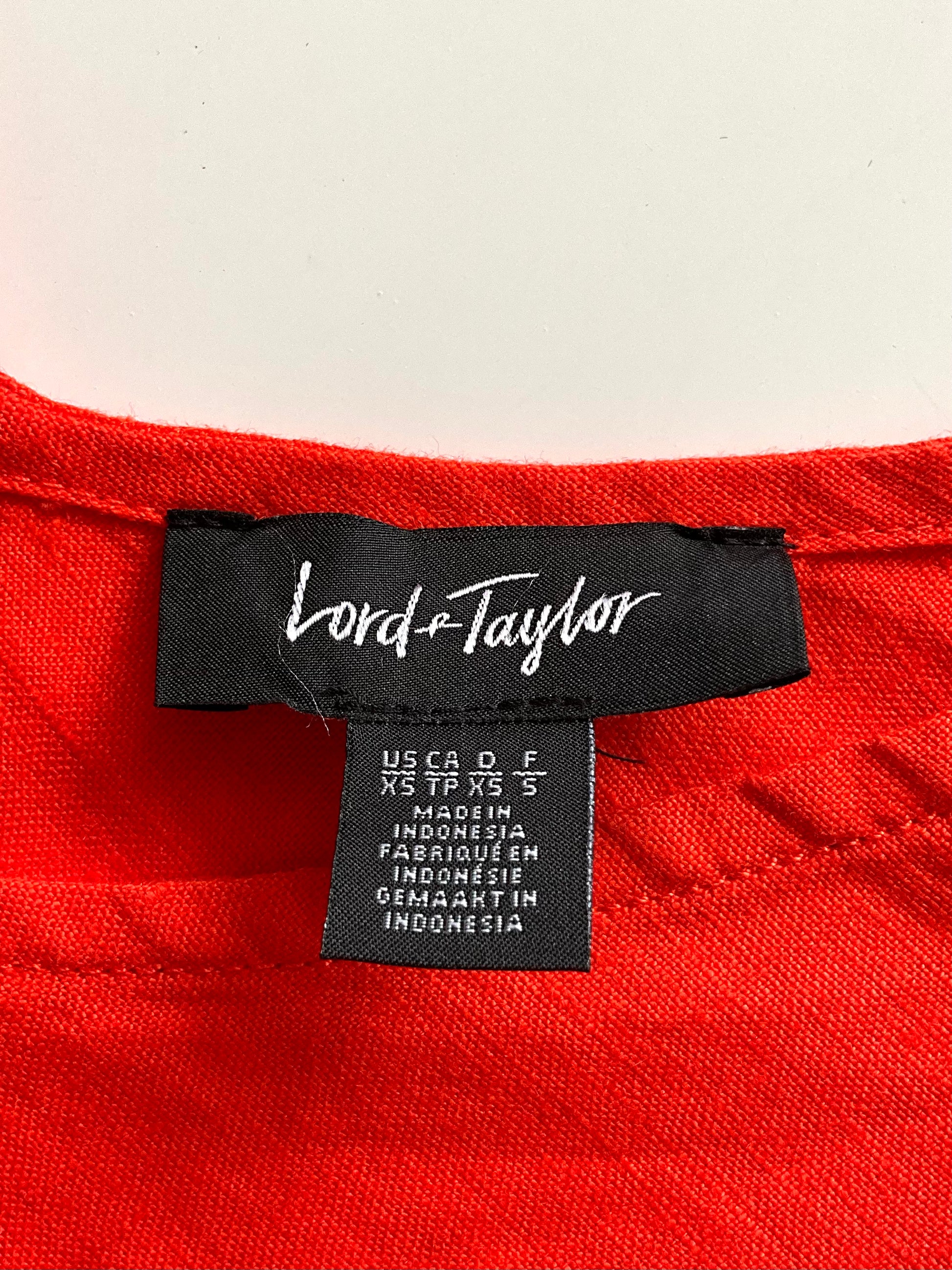 Red dress with a Lord & Taylor label on a white background