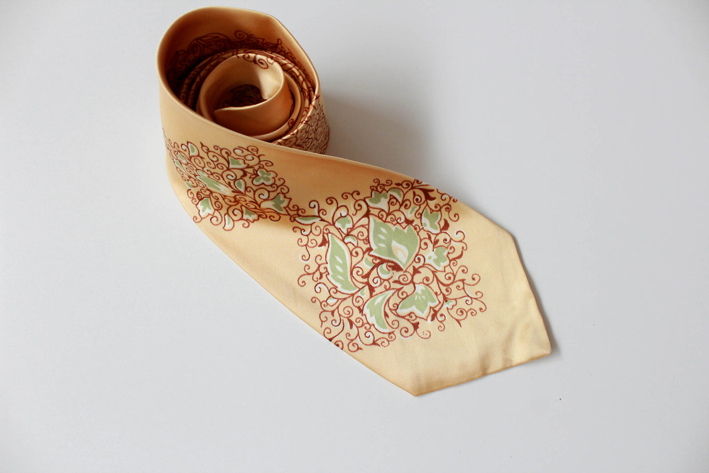 1940s yellow rayon necktie with wide tongue by Arrow. Brown and green ornate scrolling floral print design. vintage bold look necktie