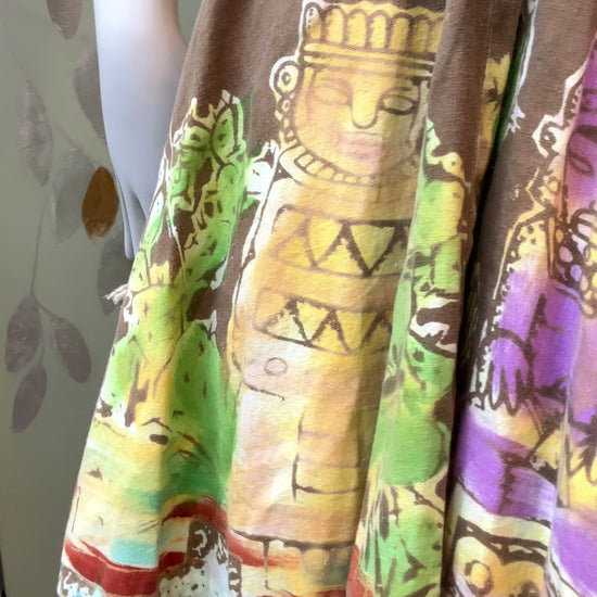 Close up of a 1950s Mexican Circle Skirt  showing print with dancing ladies and indigenous tribal statues 