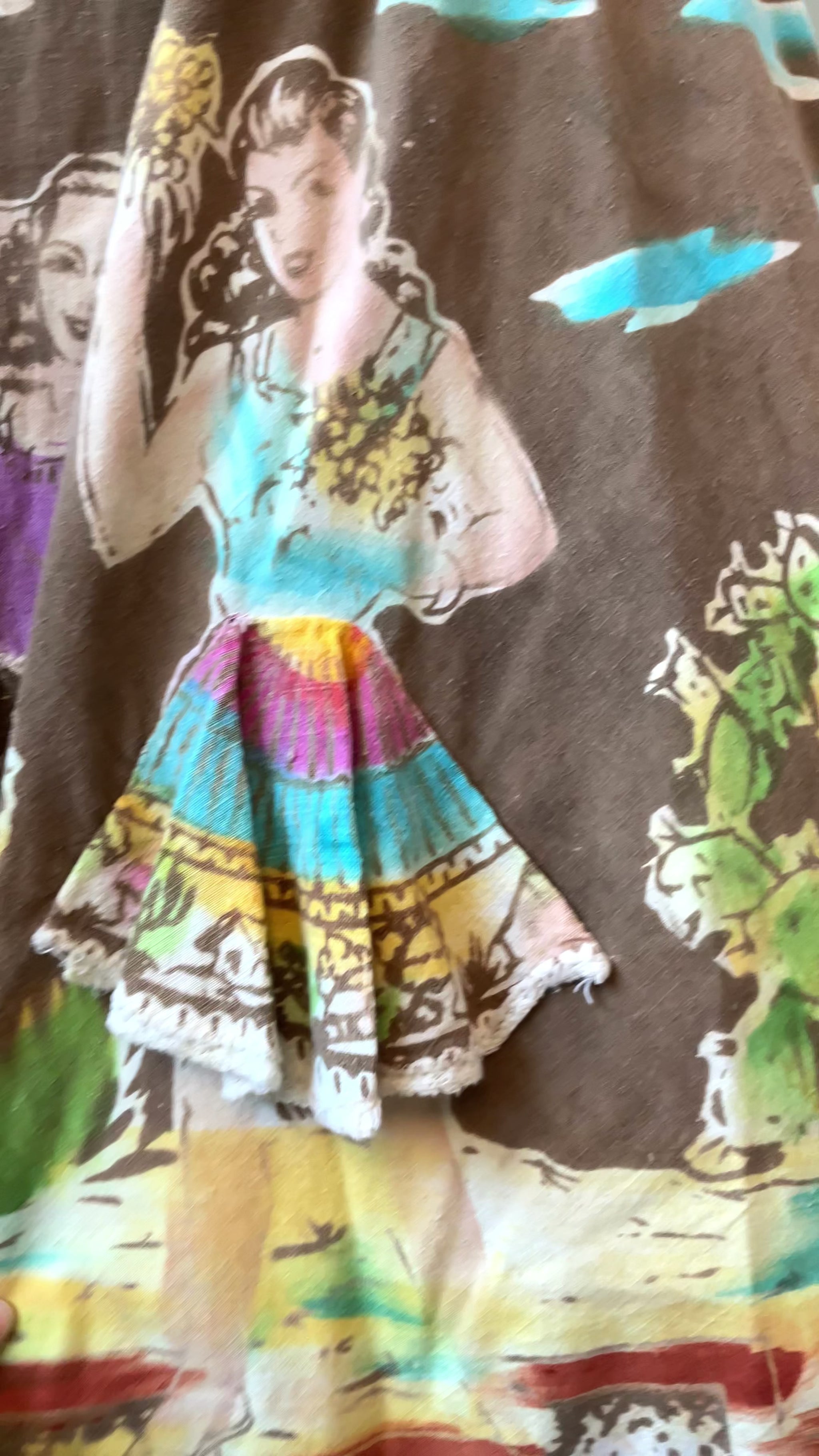 Close up of a 1950s Mexican Circle Skirt  showing print with dancing ladies and indigenous tribal statues 