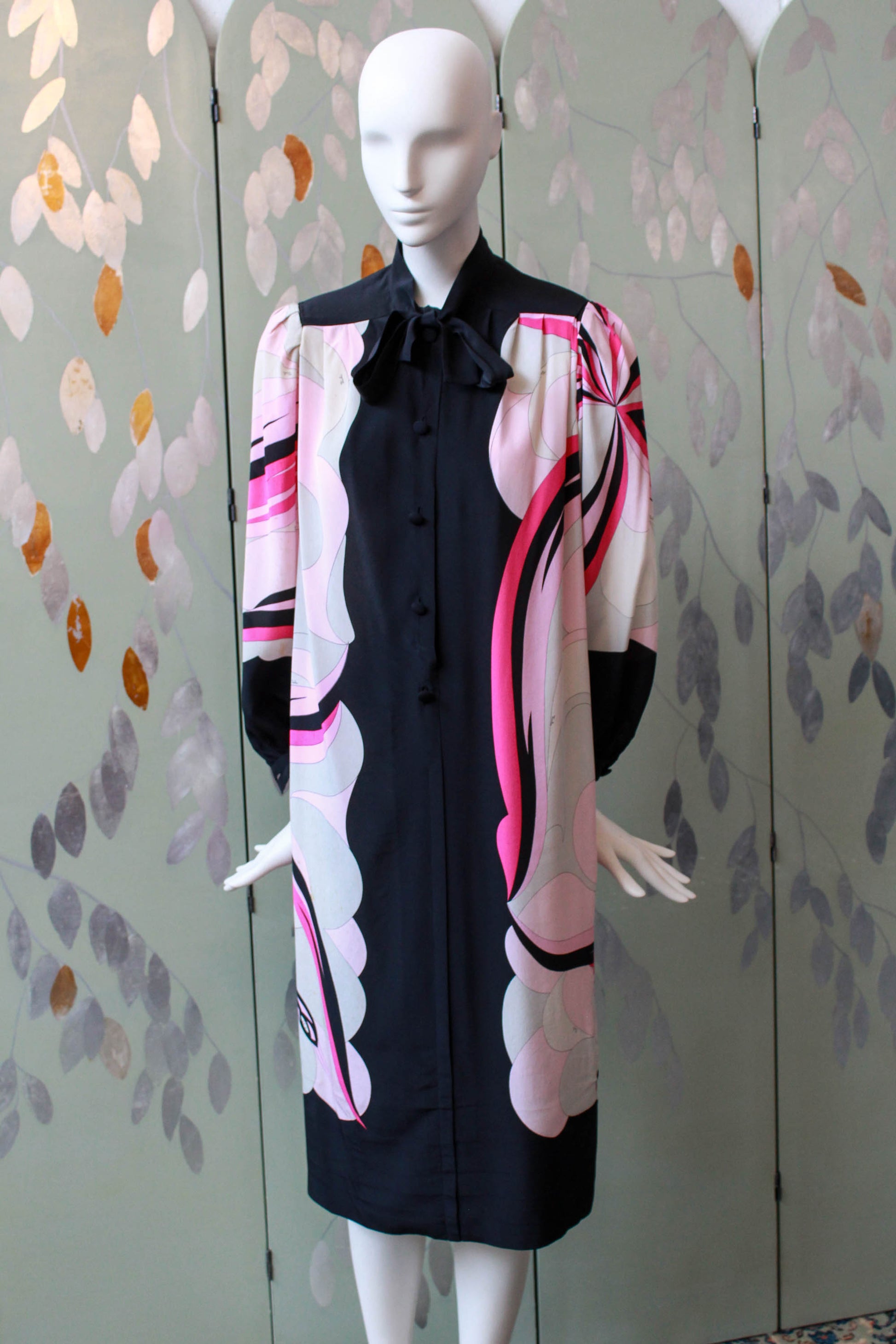 1960s emilio pucci pink and black printed dress with long sleeves, below the knee, puff sleeves and tie at neck. button front design