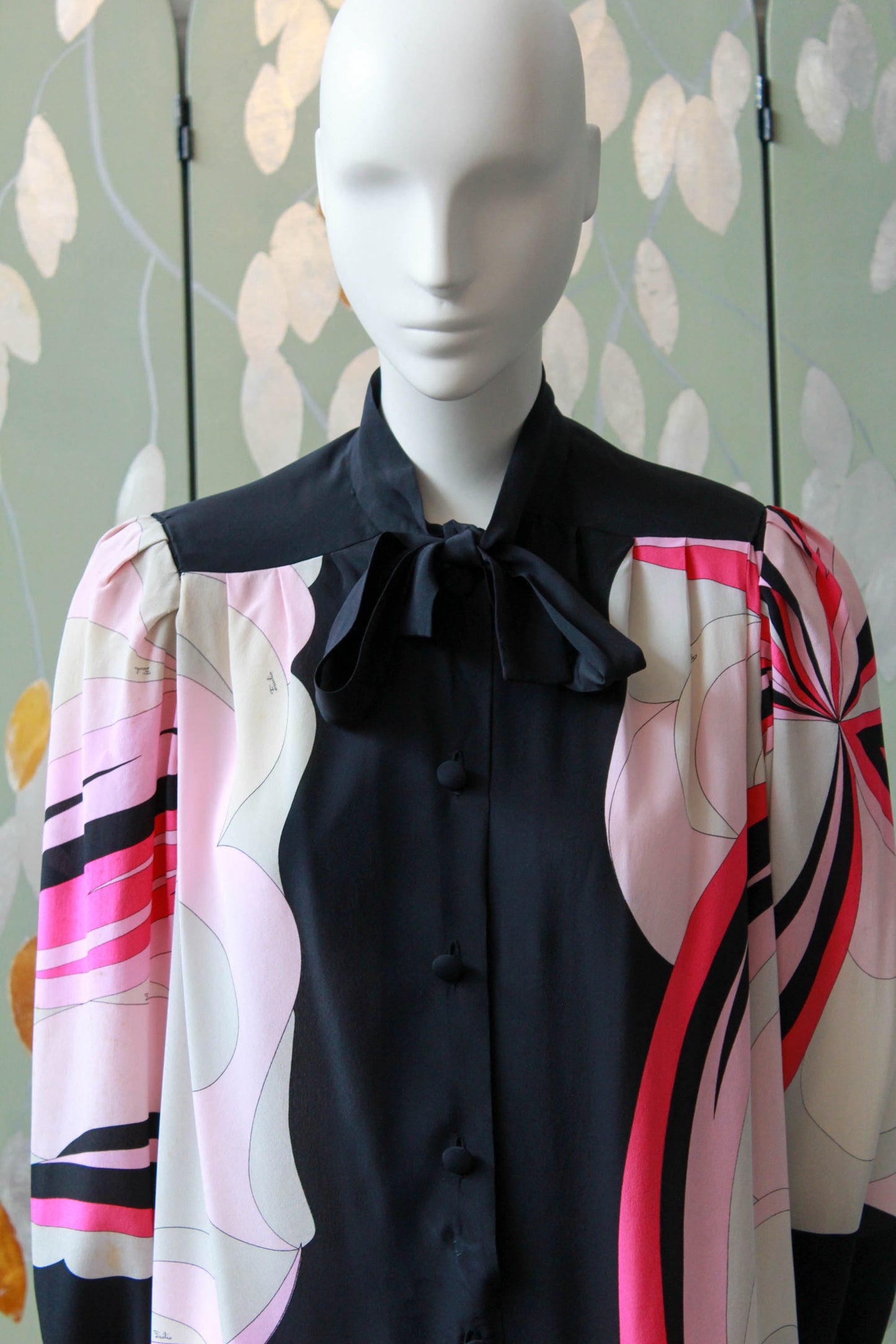 1960s emilio pucci pink and black printed dress with long sleeves, below the knee, puff sleeves and tie at neck. button front design