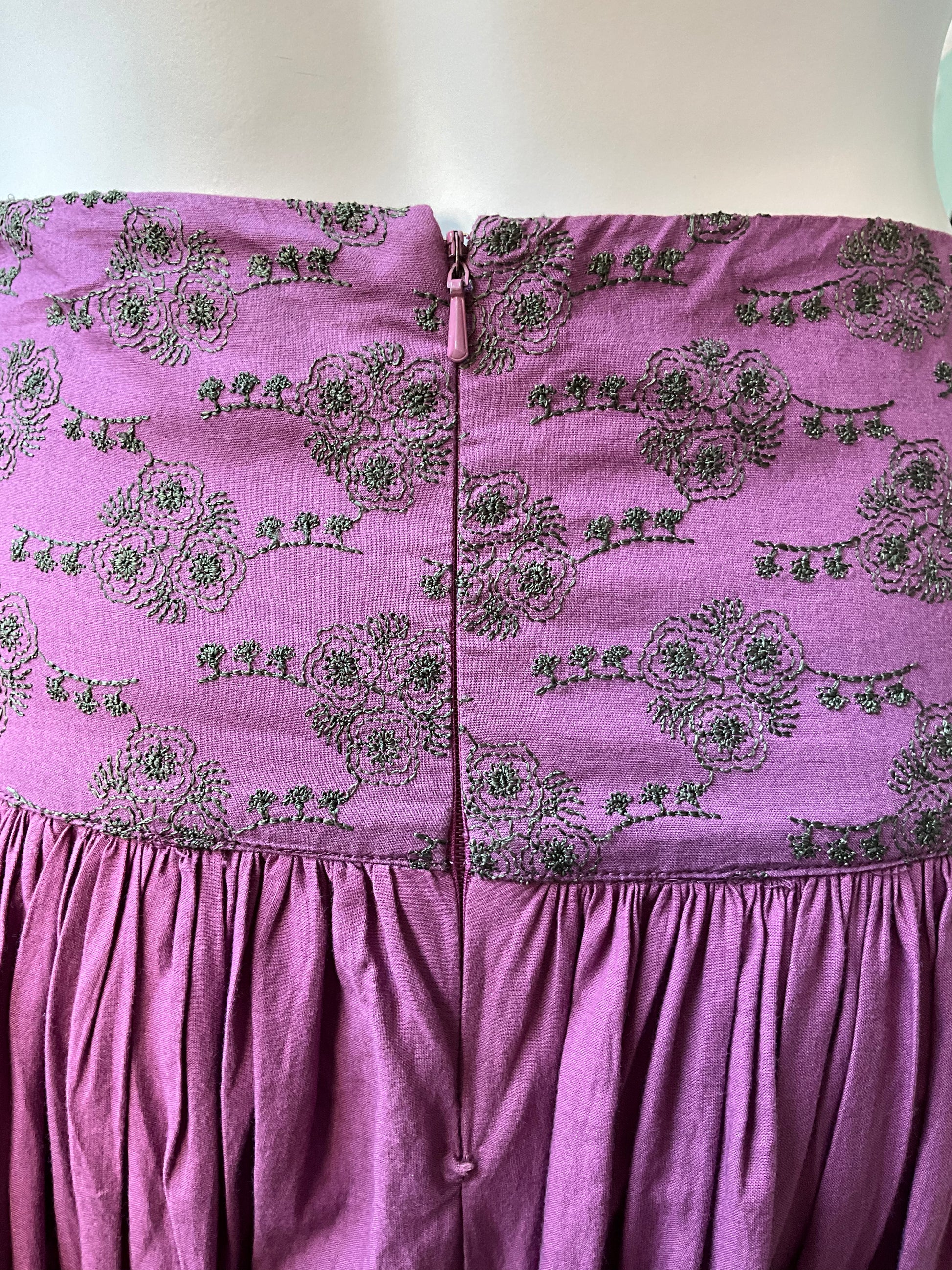 Purple dress with floral pattern on a mannequin