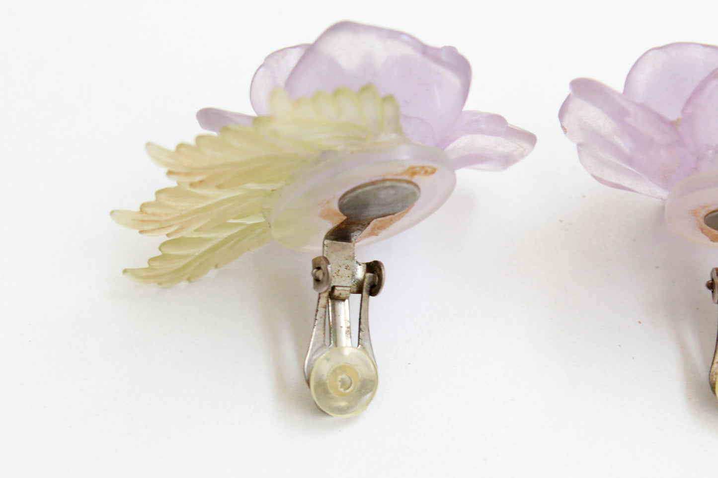 lilac plastic rose statement earrings, with translucent green leaves and rhinestone centres. vintage clip on earrings