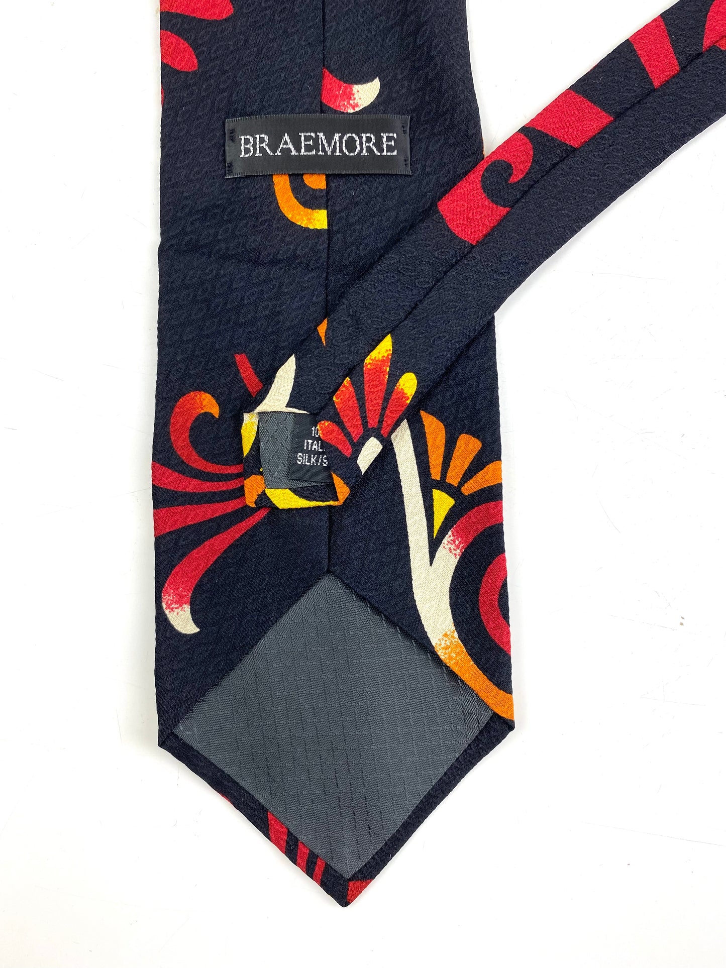 Back and labels of: 90s Deadstock Silk Necktie, Men's Vintage Red/ Orange Tikki Pattern Tie, NOS