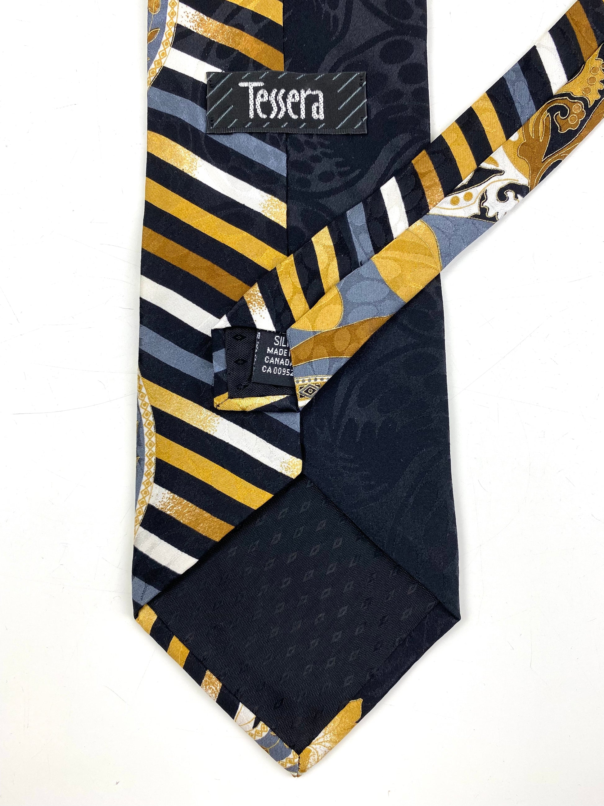 Back and labels of: 90s Deadstock Silk Necktie, Men's Vintage Black/ Gold Foliage Pattern Tie, NOS
