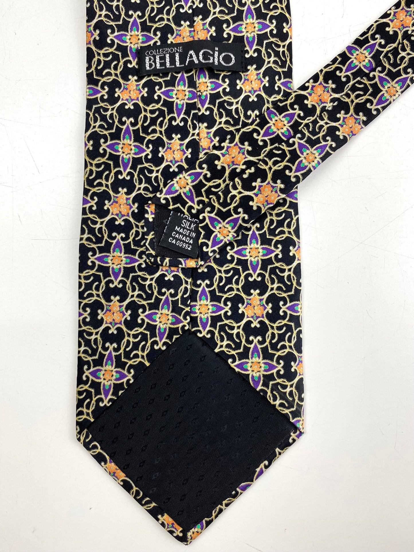Back and labels of: 90s Deadstock Silk Necktie, Men's Vintage Black/ Purple/ Gold Geometric Art Deco Pattern Tie, NOS