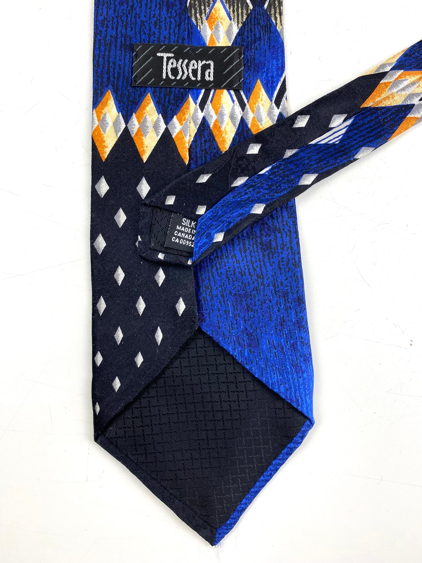Back and labels of: 90s Deadstock Silk Necktie, Men's Vintage Black/Blue Geometric Art Deco Pattern Tie, NOS