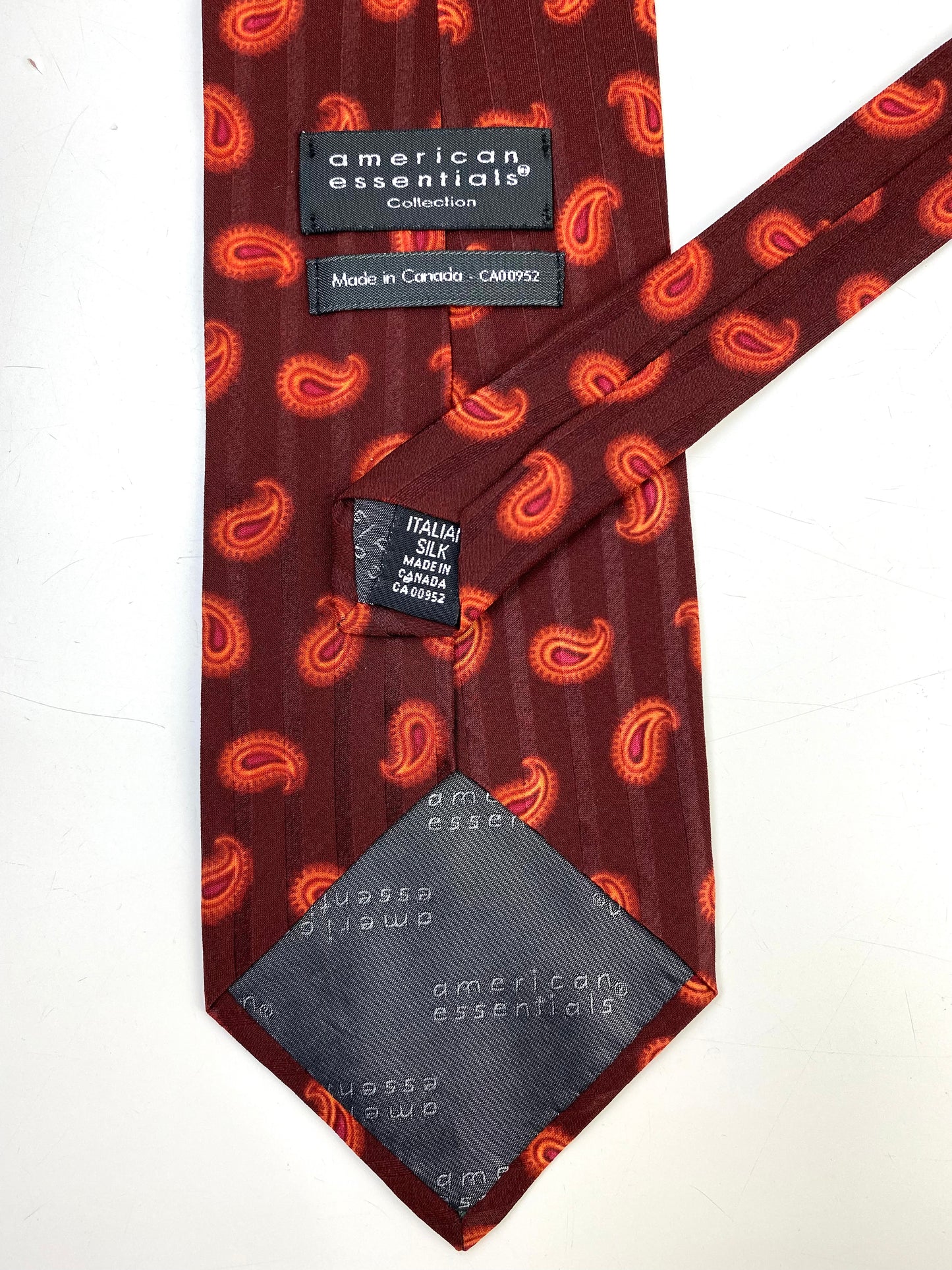 Back and labels of: 90s Deadstock Silk Necktie, Men's Vintage Red/ Orange Paisley Boteh Pattern Tie, NOS