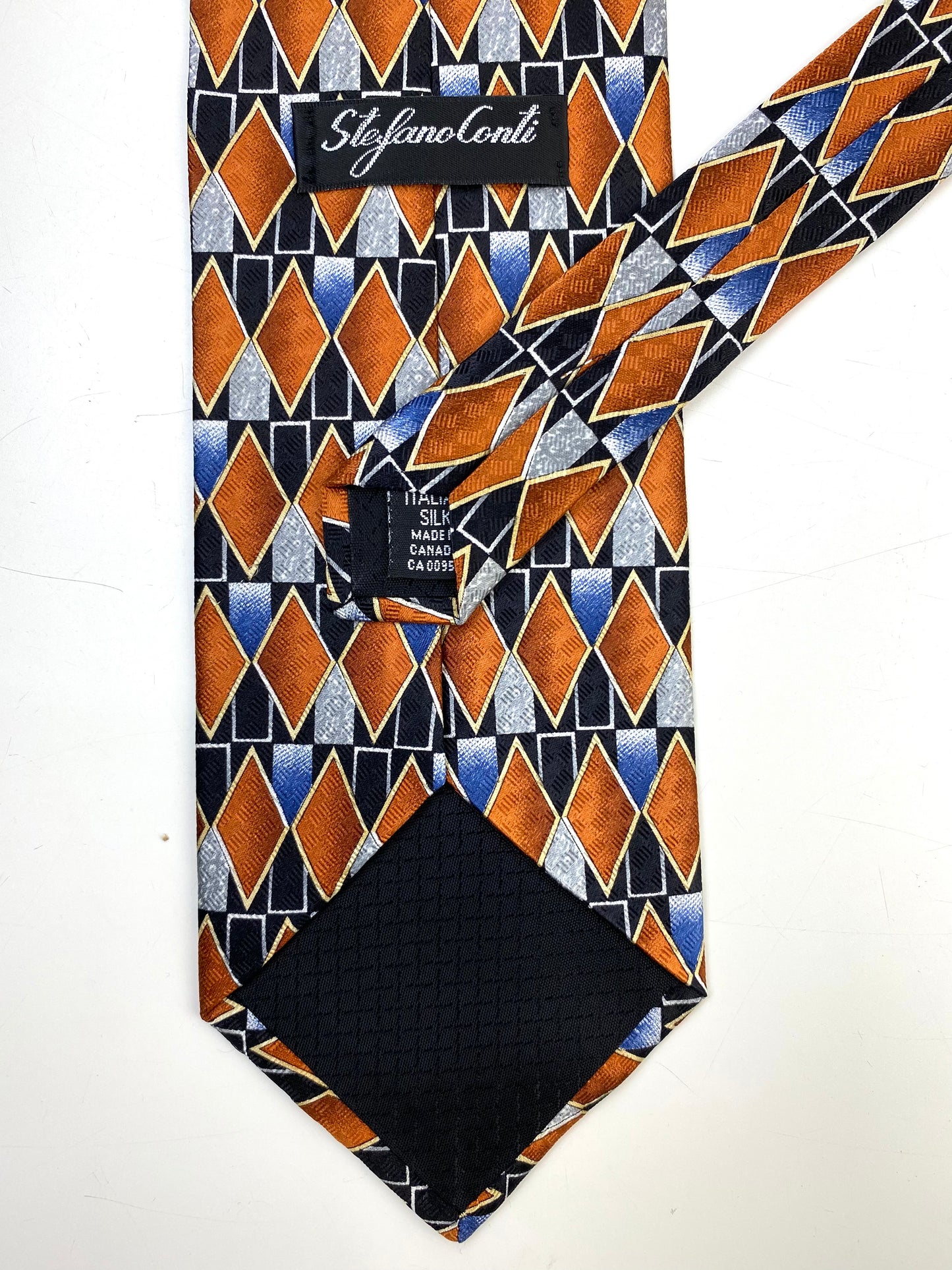 Back and labels of: 90s Deadstock Silk Necktie, Men's Vintage Black/ Brown/ Blue Geometric Pattern Tie, NOS