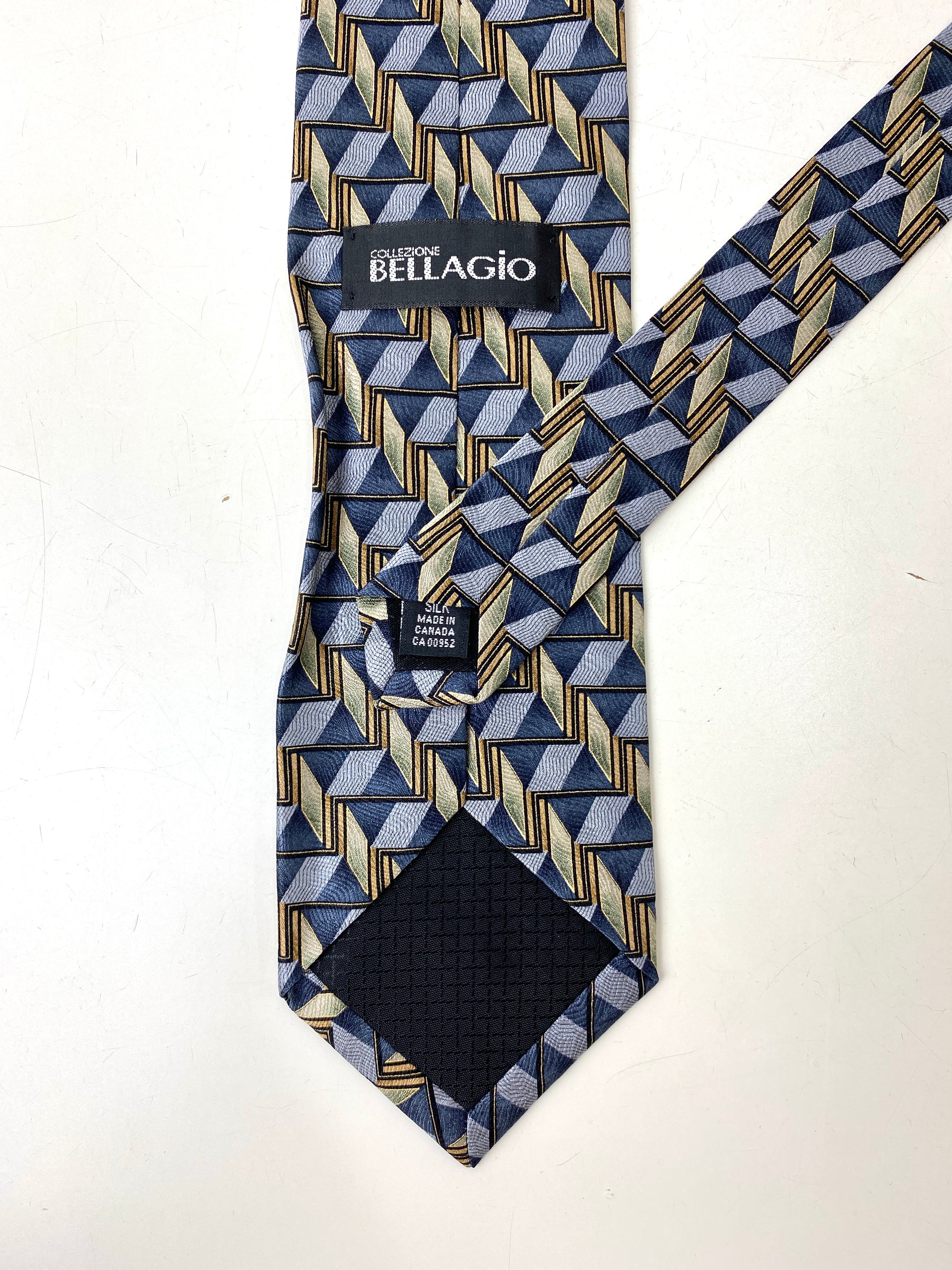 Back and labels of: 90s Deadstock Silk Necktie, Men's Vintage Grey/ Gold Geometric Pattern Tie, NOS