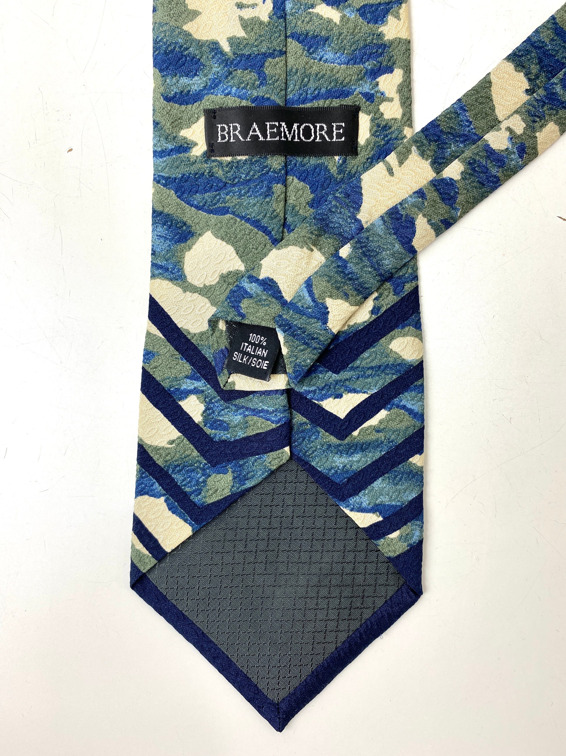 Back and labels of: 90s Deadstock Silk Necktie, Men's Vintage Blue/ Green/ Tan Abstract Camo Pattern, NOS