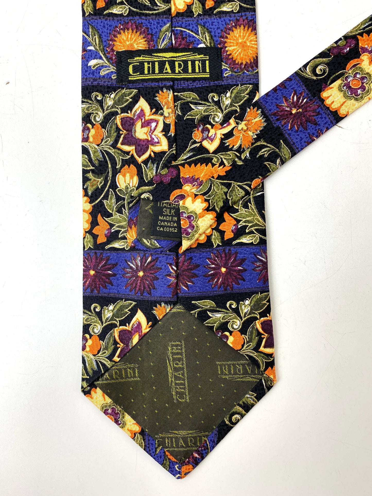 Back and labels of: 90s Deadstock Necktie, Men's Vintage Black/ Purple/ Orange Floral Print Tie, NOS