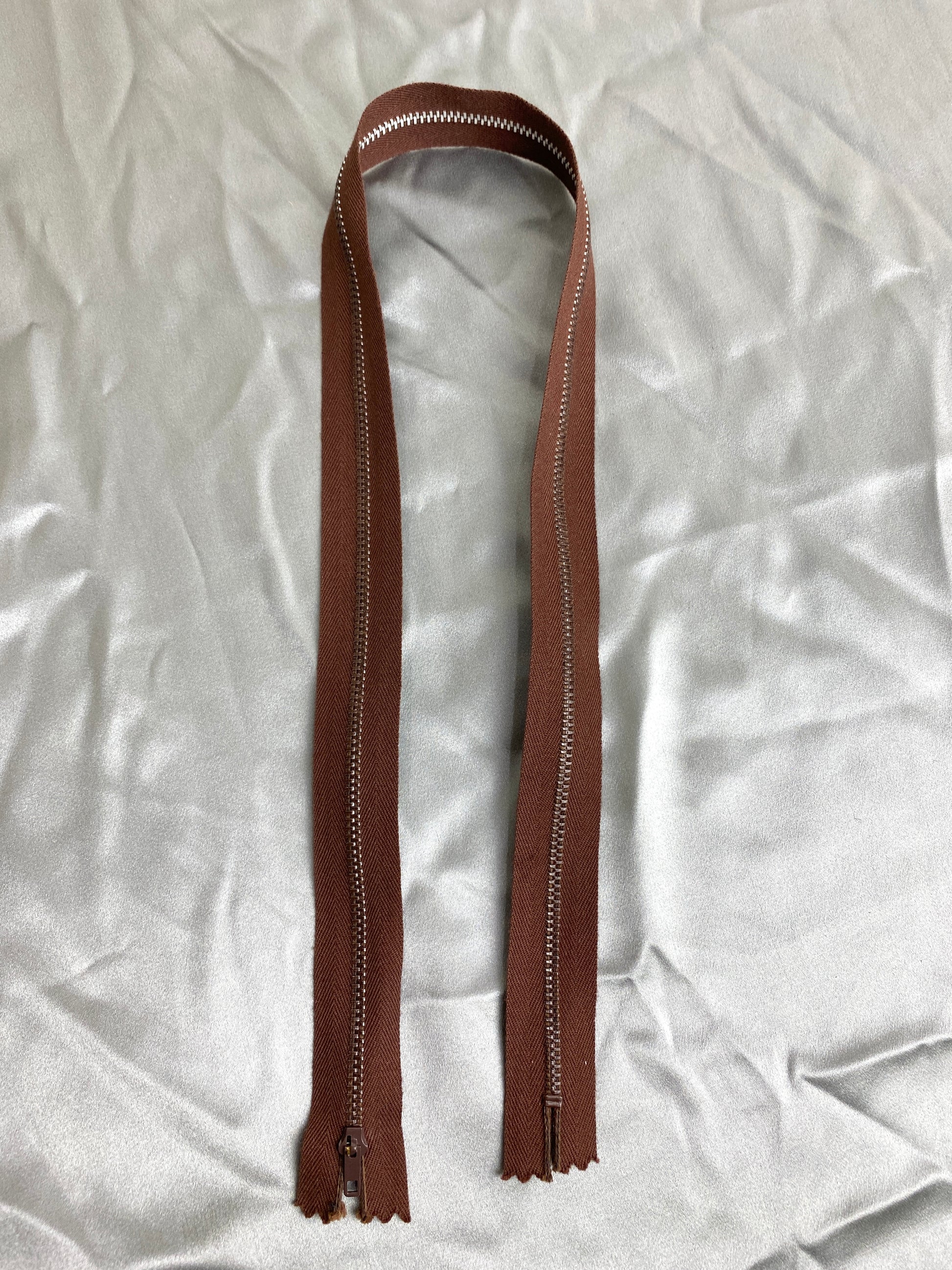 A single dark brown vintage metal zipper. Ian Drummond Vintage. 