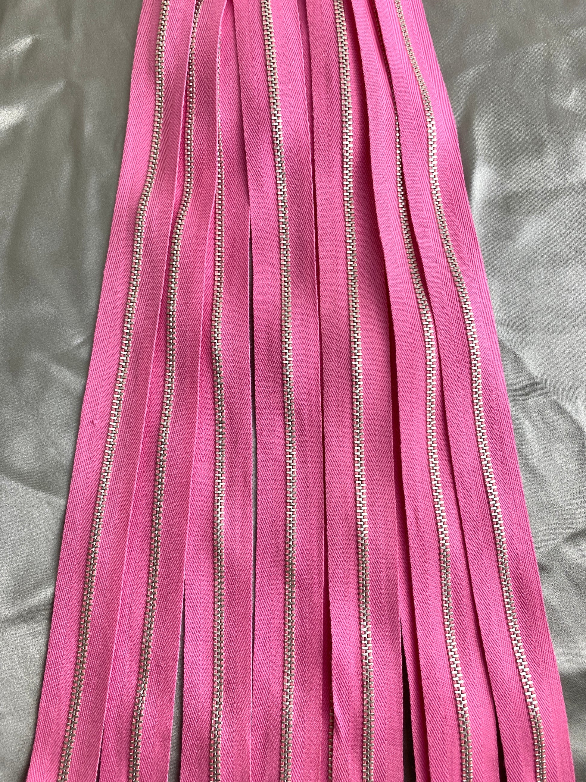 A batch of vintage pink metal zippers. Ian Drummond Vintage. 