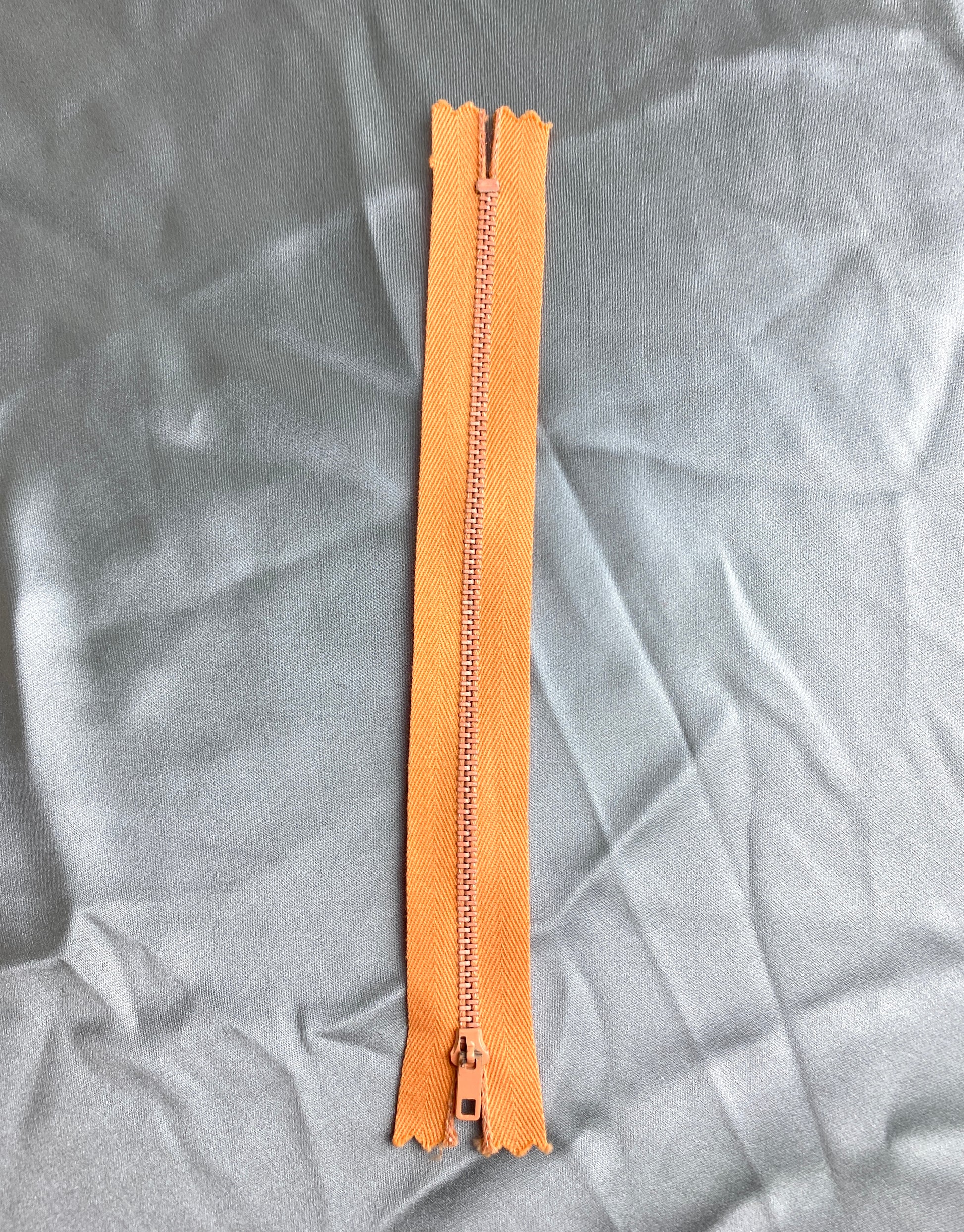 A single metal zipper. Vintage light orange colour. Ian Drummond Vintage. 