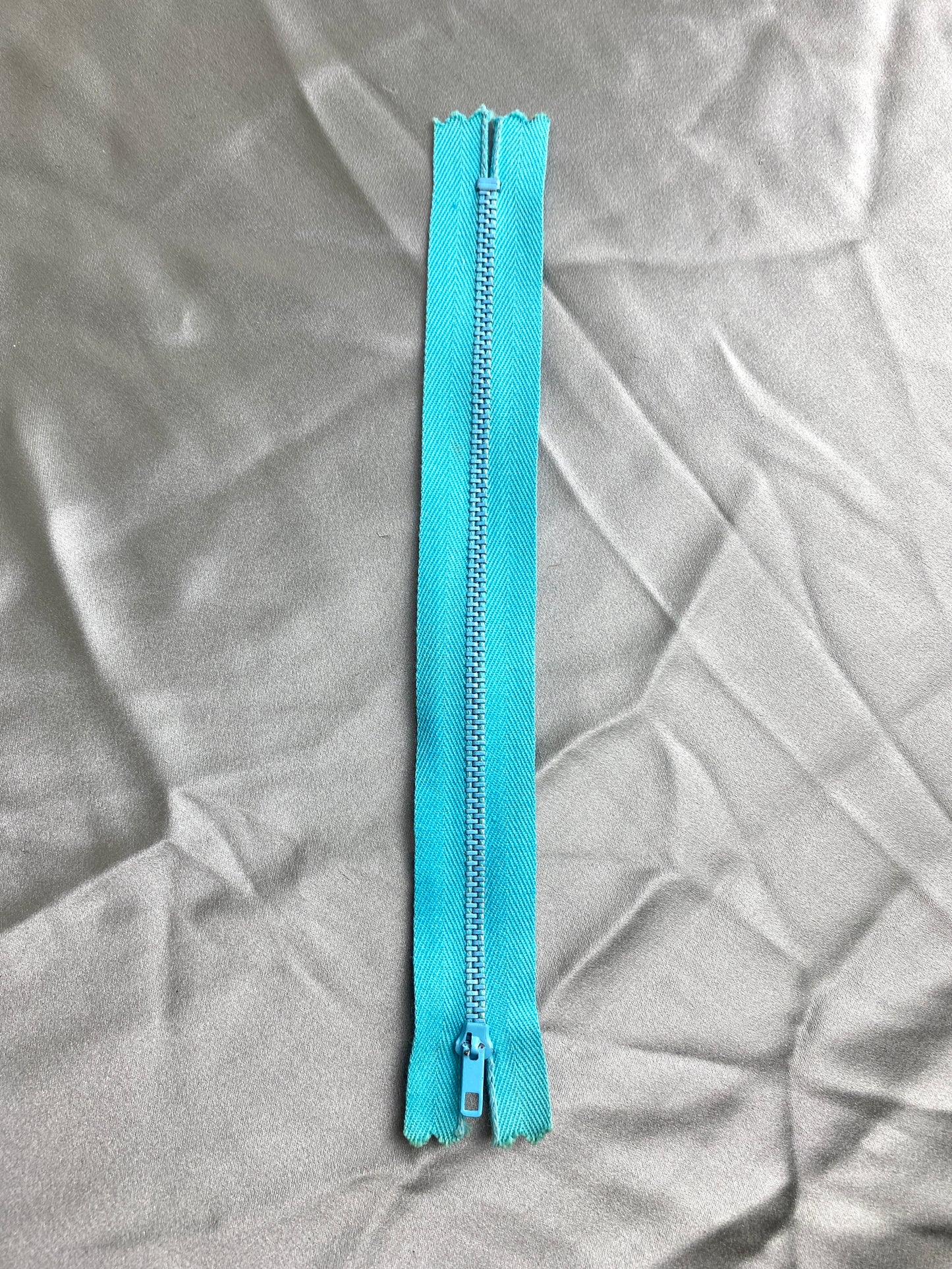 A single light blue metal vintage zipper. Ian Drummond Vintage. 