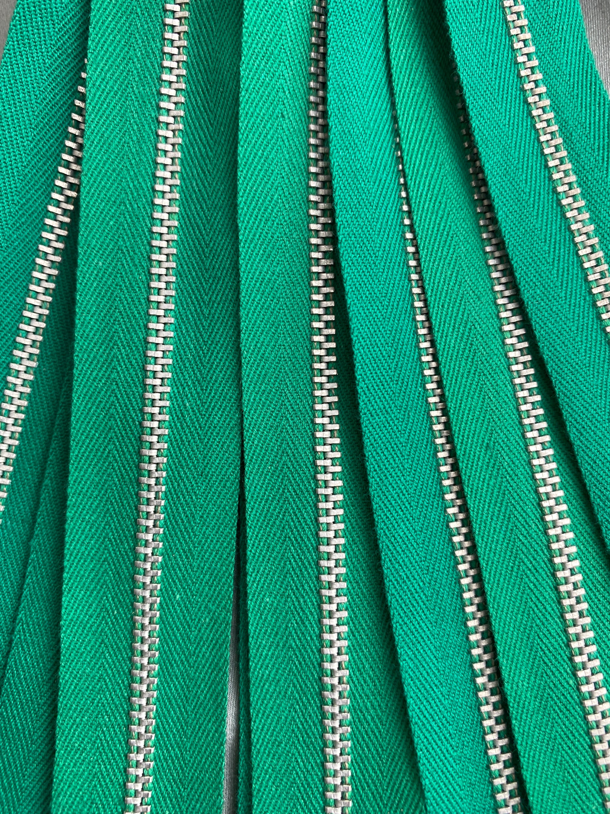 Close-up of deep green metal zippers. Ian Drummond Vintage. 