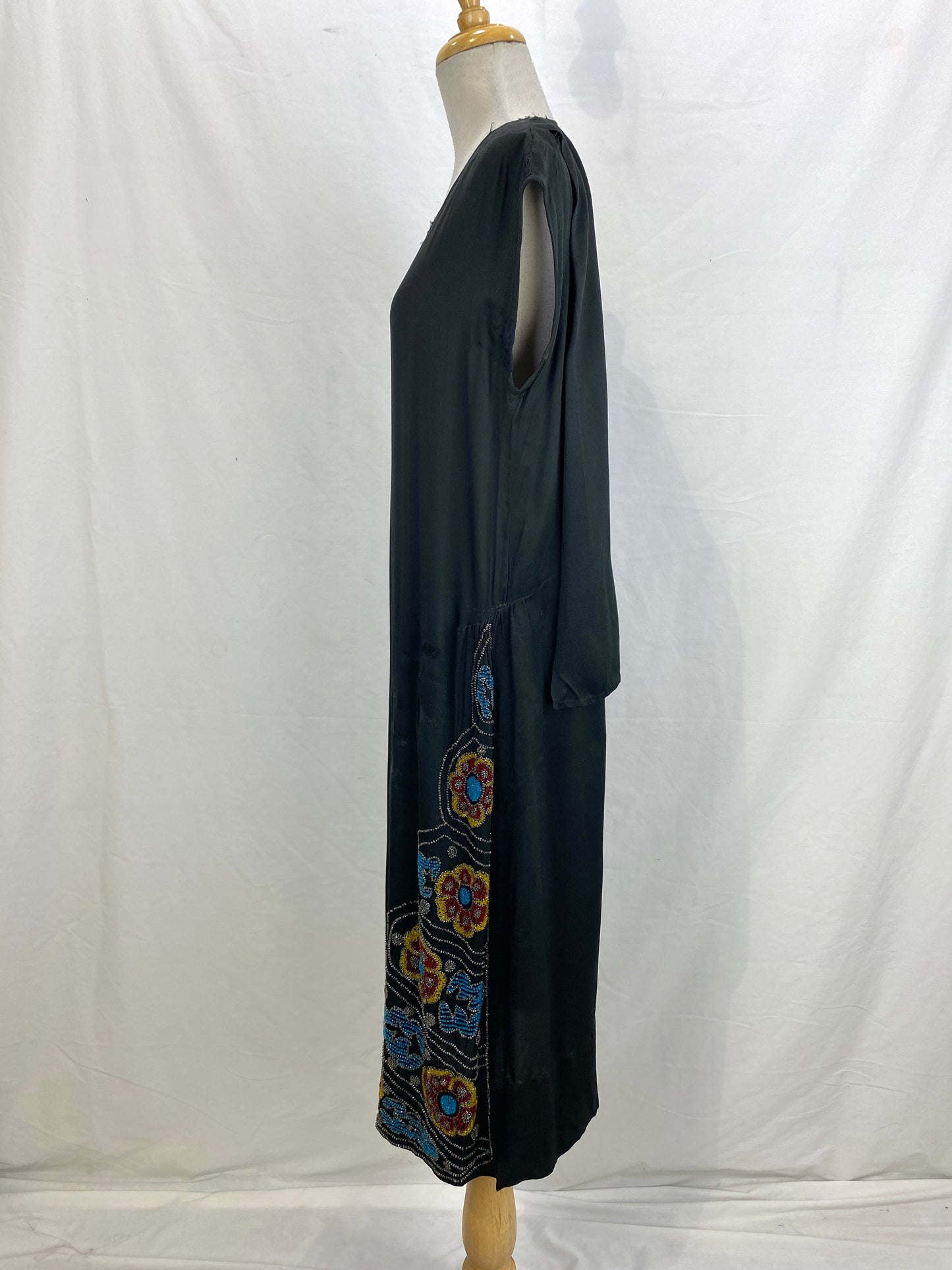 Left side view of black silk sleeveless beaded flapper dress. Ian Drummond Vintage. 