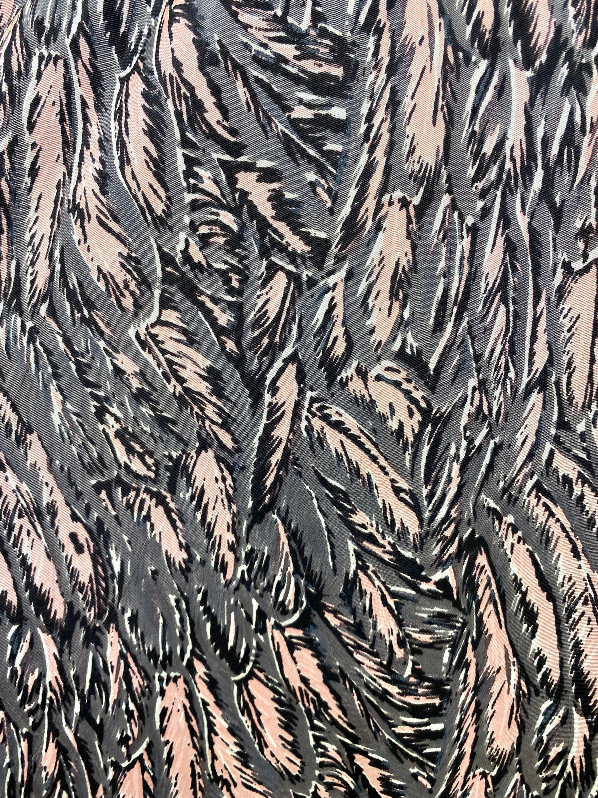 Close-up detail of grey & pink feather print fabric on 1950s dress. Ian Drummond Vintage. 
