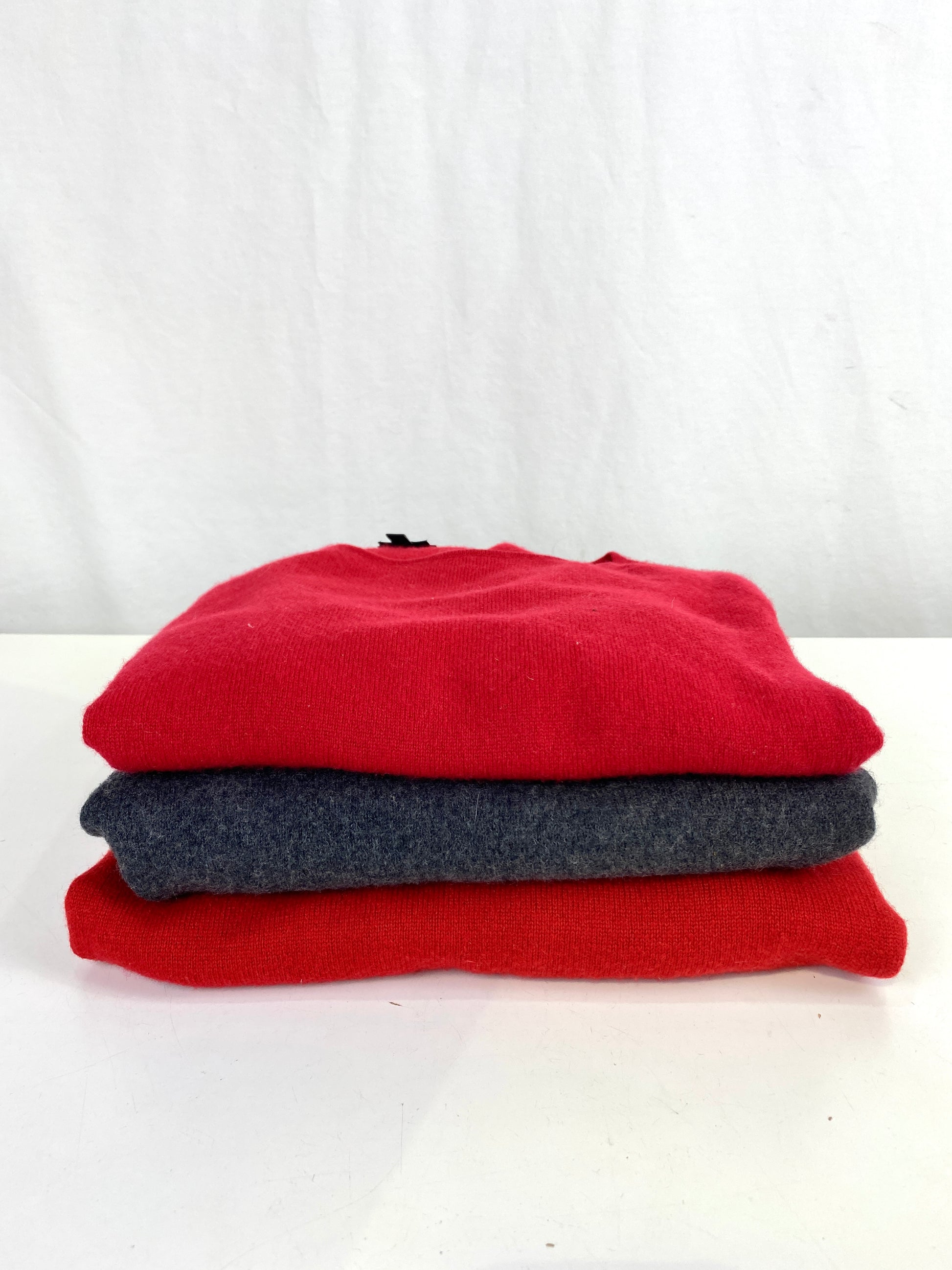 Vintage cashmere sweaters folded and stacked. Ian Drummond Vintage. 